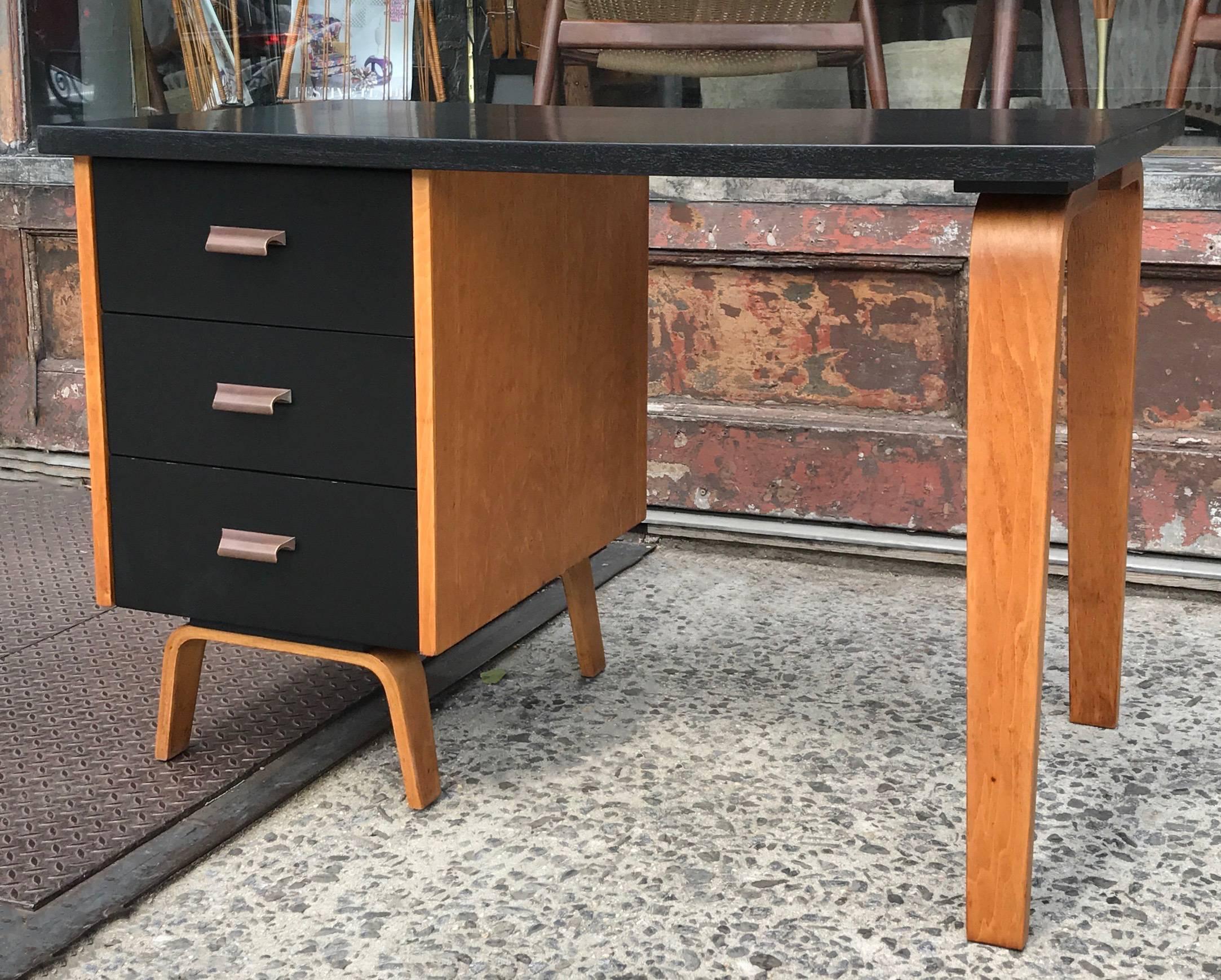 Mid-Century Modern, two-toned, bent-maple-wood, desk by Clifford Pascoe features a black lacquered top and drawers with natural trim and polished copper pulls.