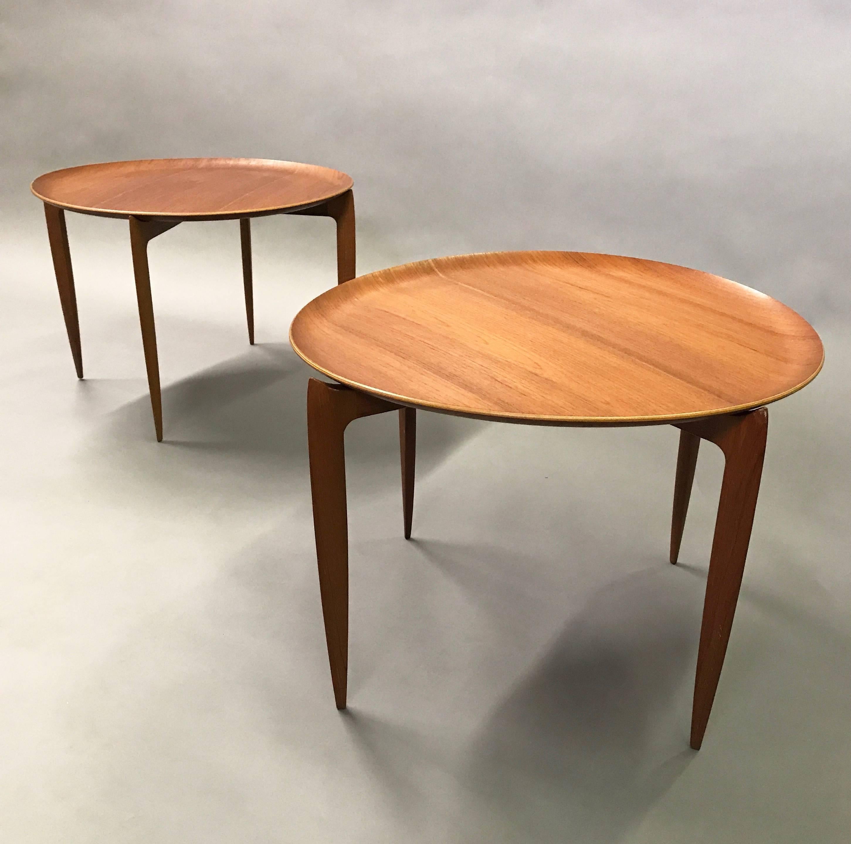 Danish modern, sculpted, teak, side tables designed by H. Engholm and Sven Aage Willumsen for Fritz Hansen with removable tray tops and folding bases.