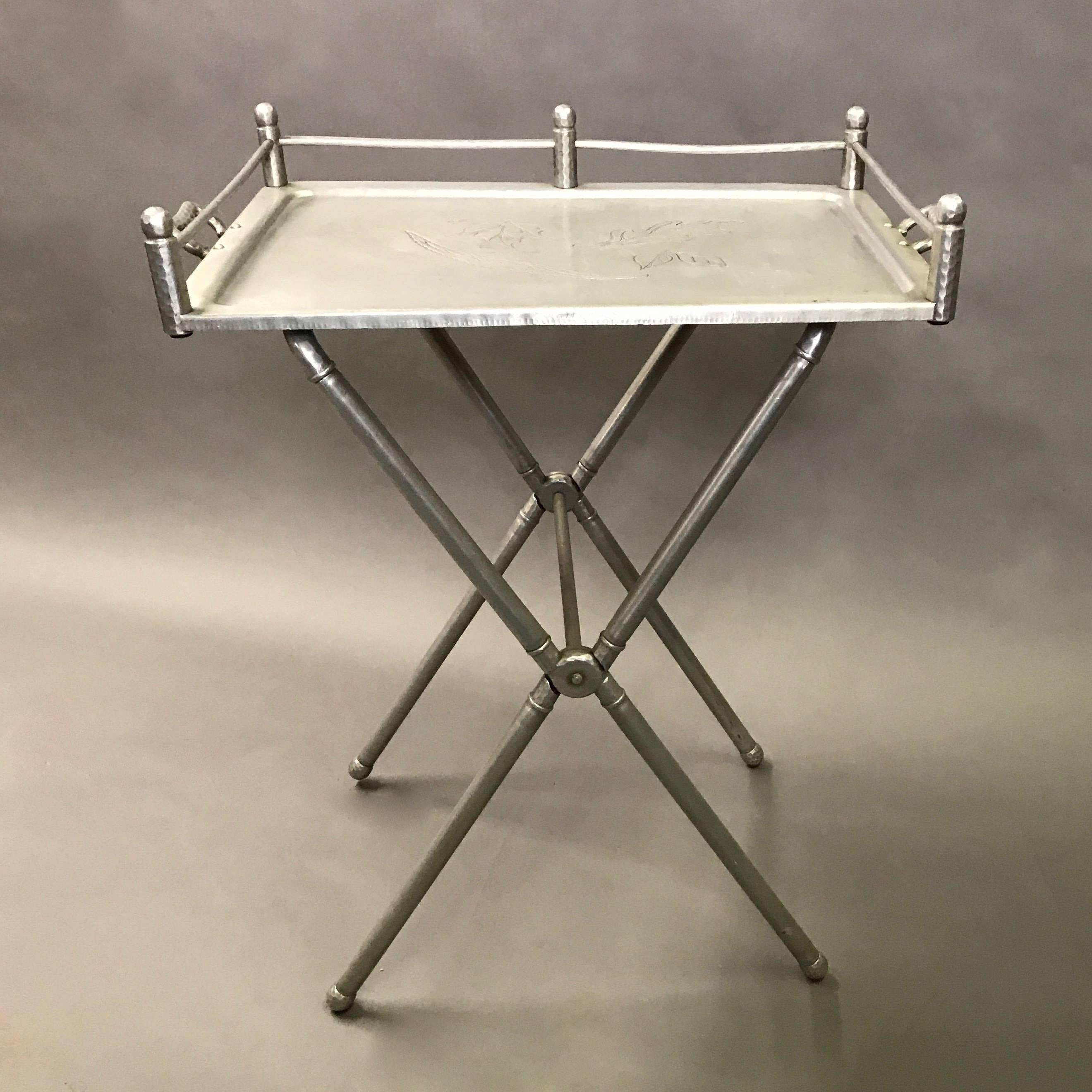Hollywood Regency, hand-wrought, bar tray table produced by Everlast Metal Products Corp. features folding table base and removable tray with foliate engravings designed by Mary Wright.
