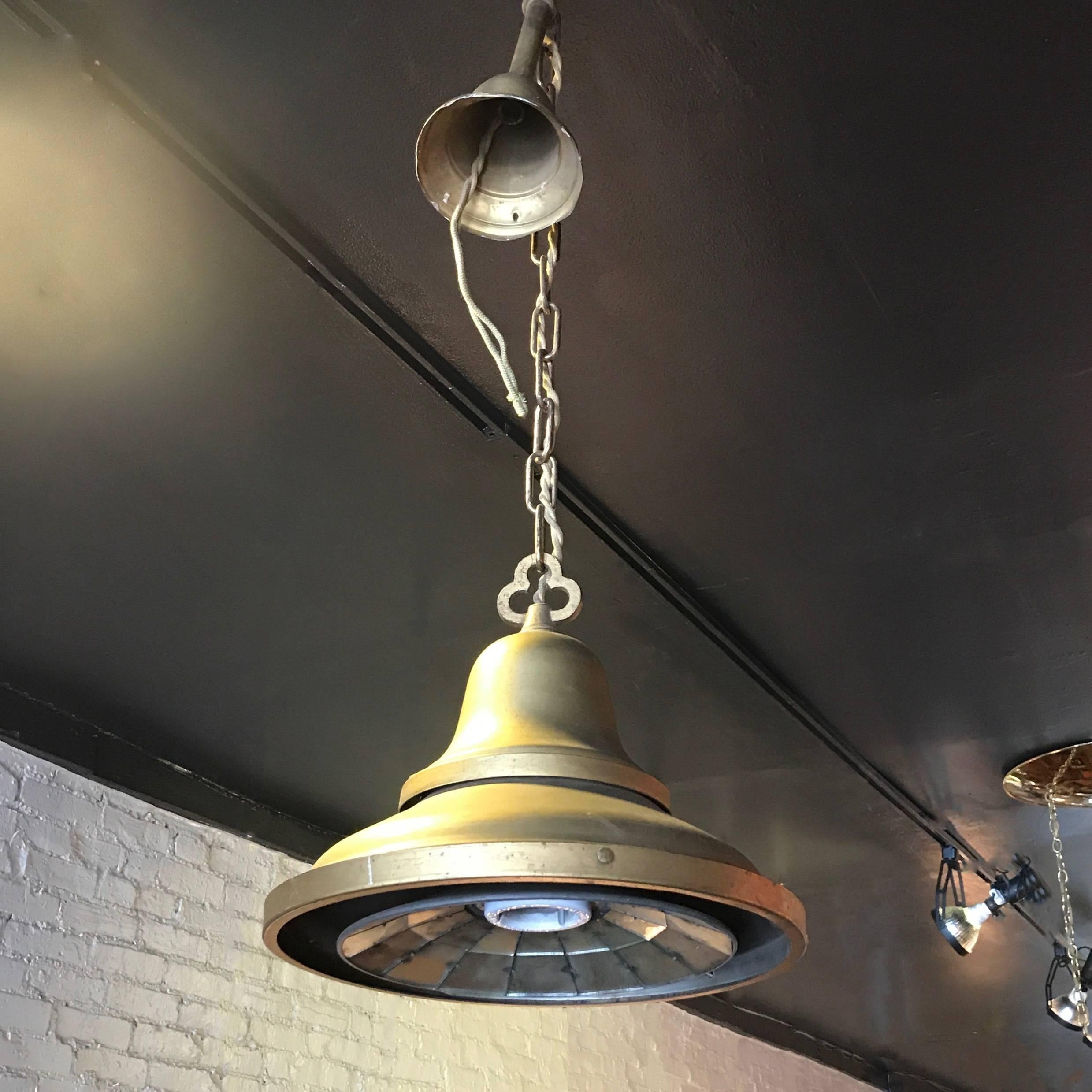 All original, 1920s, painted steel, factory pendant light features a dropped faceted mirror plate with porcelain socket with chain and canopy. The pendant is newly wired and can accept up to a 200 watt bulb. Overall height is 36 in.