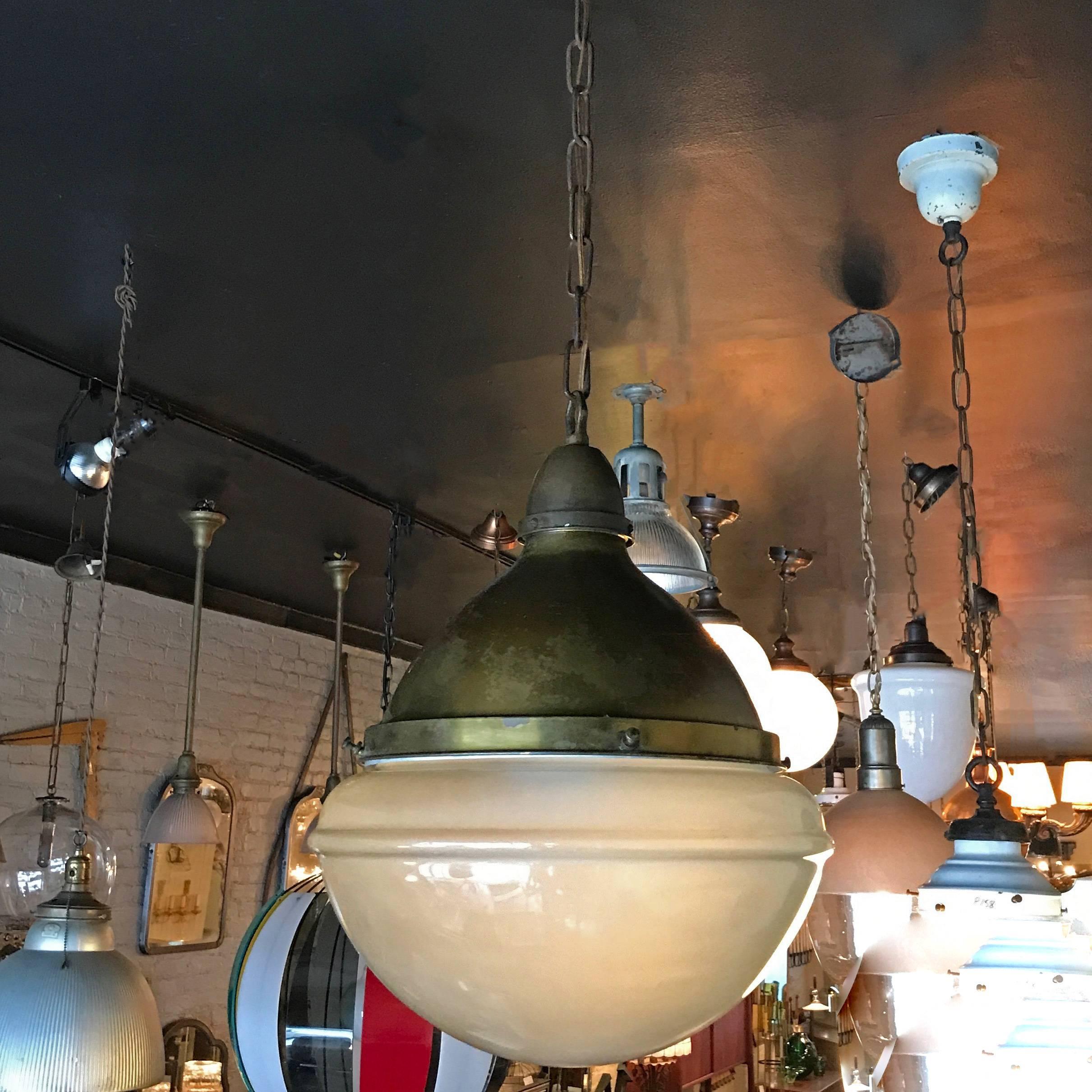 Vintage, early 20th century, oversized and impressive, library or pharmacy pendant light features an acid washed glass shade with original patinated, spun steel fitter, canopy and chain is newly wired to accept up to 300 watts. Overall height: 41 in.