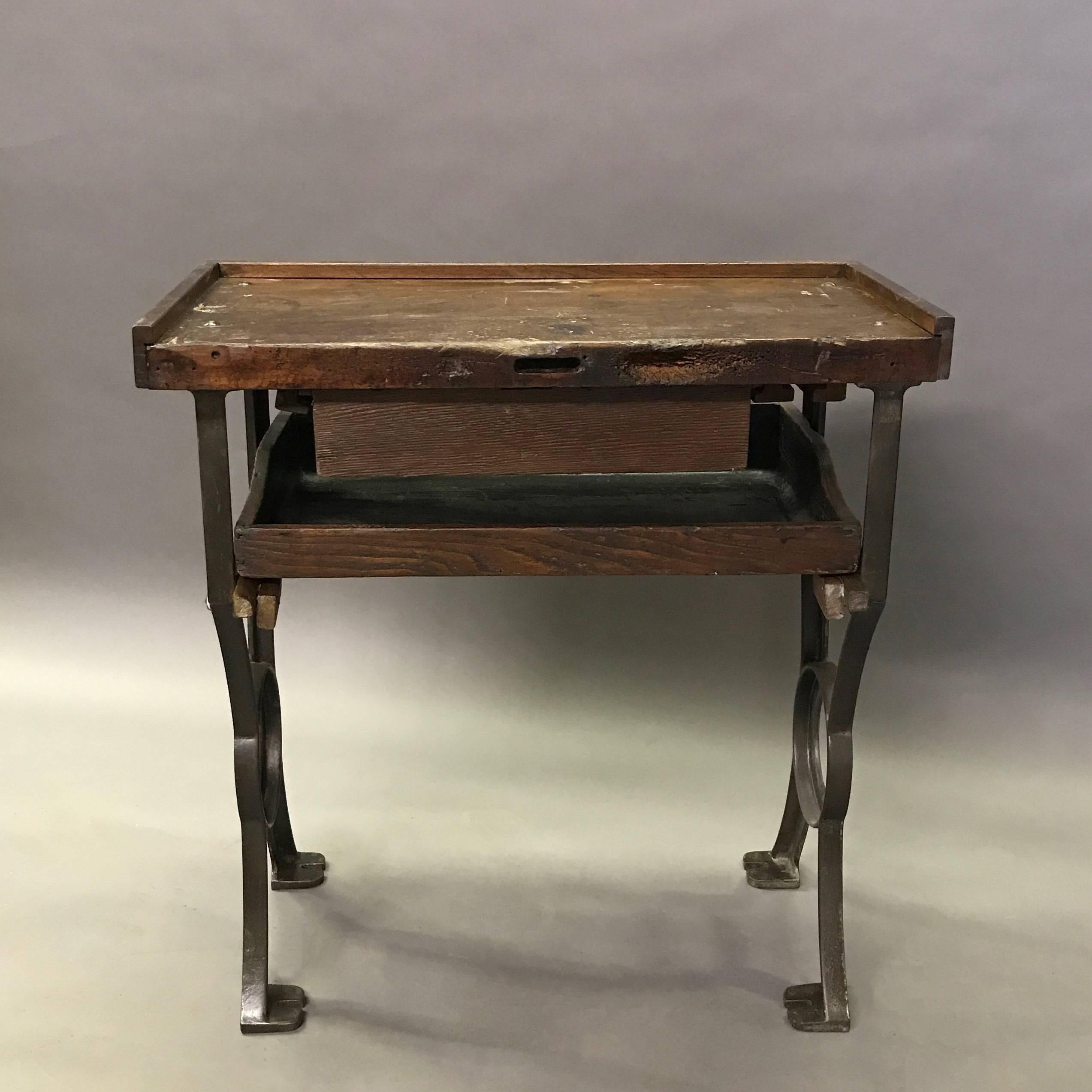 Vintage, 1930s, Industrial, jeweler's bench or table features a beautifully rustic, work worn maple top stained to a walnut finish with two pull-out drawers in a cast iron frame. A double and triple bench are also available.