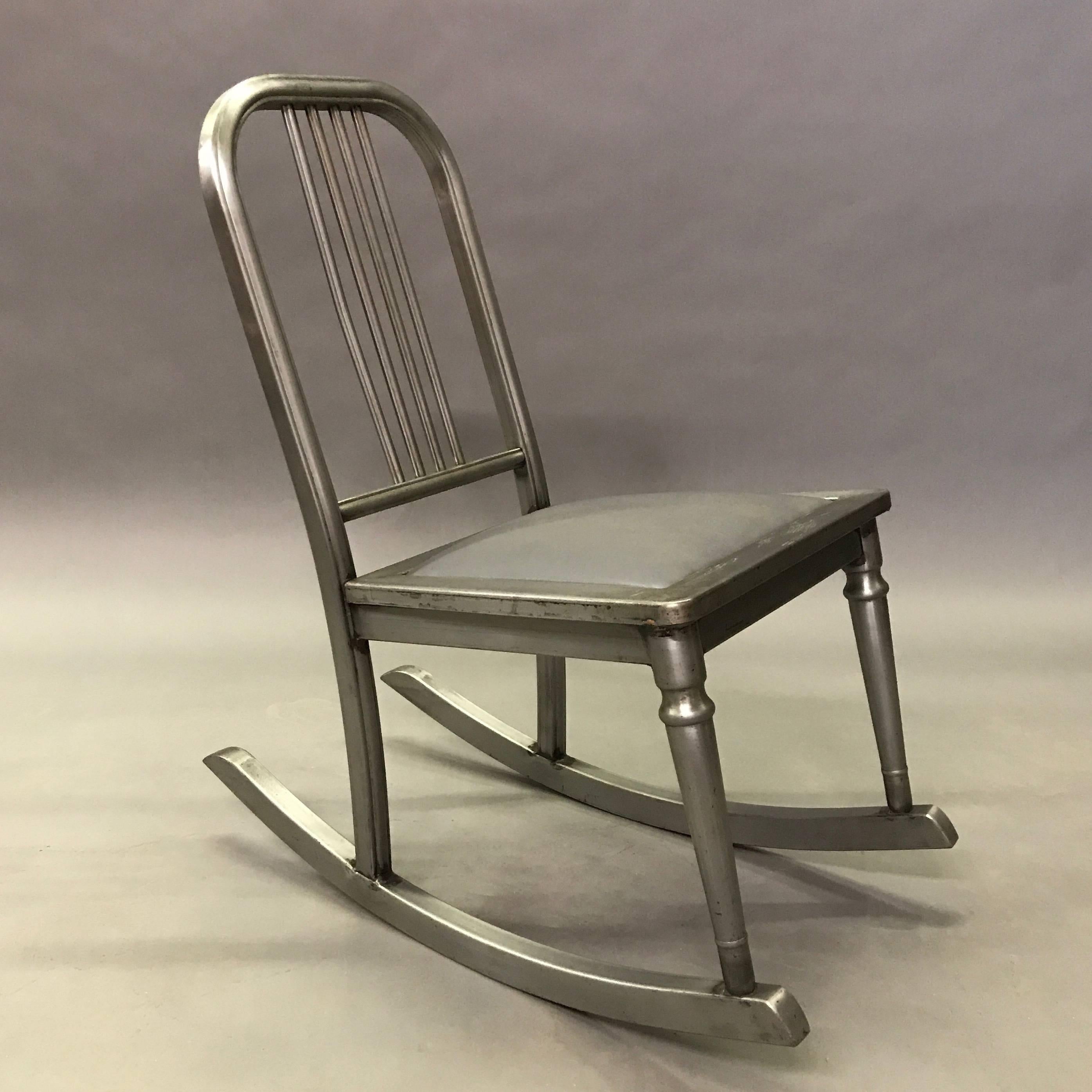 Petite, Industrial, brushed steel rocking chair with upholstered gunmetal vinyl seat is from the Sheraton Series by Simmons Company Furniture, circa 1920s.