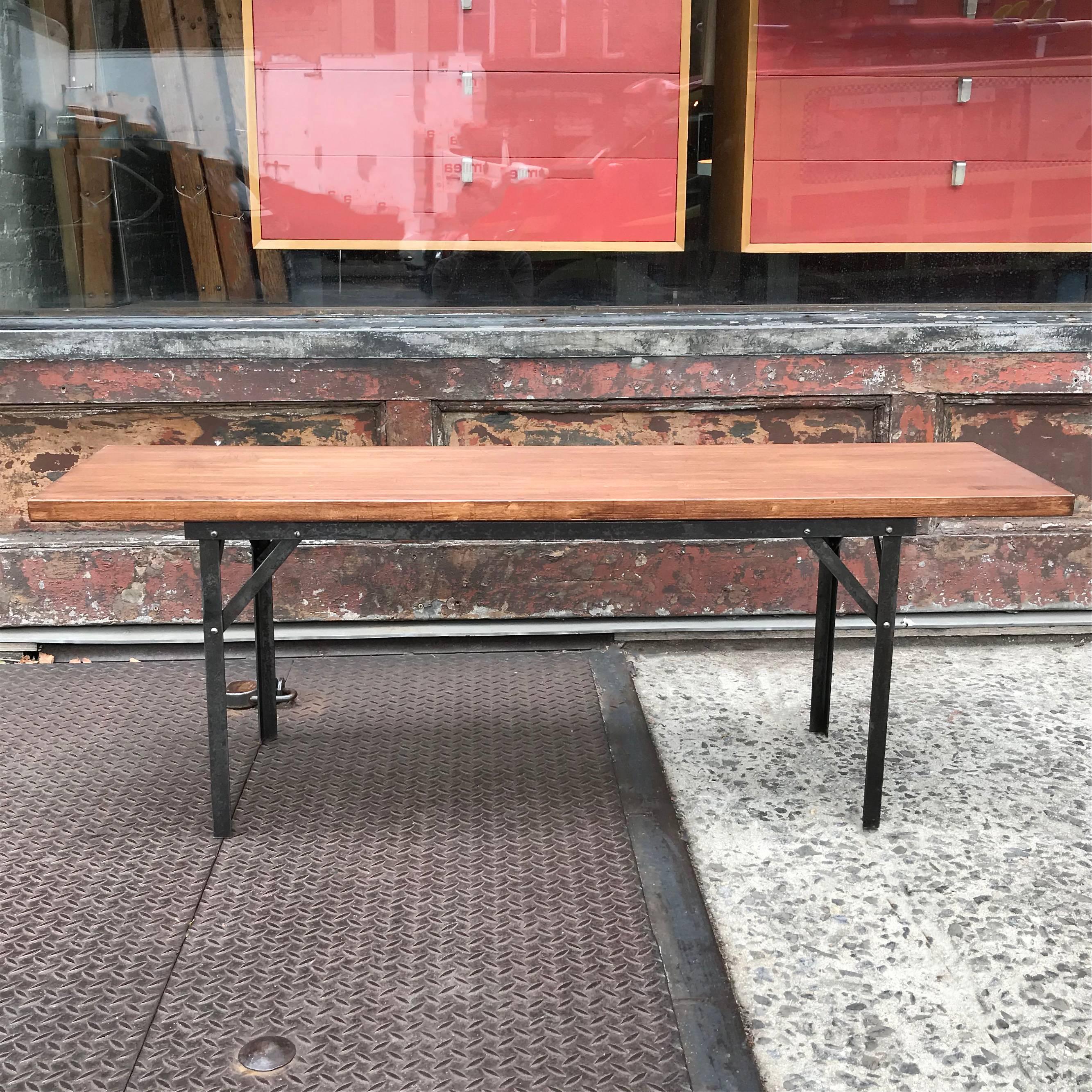 Industrial bench features a stripped, vintage angle iron base with reclaimed, stained, maple block top.