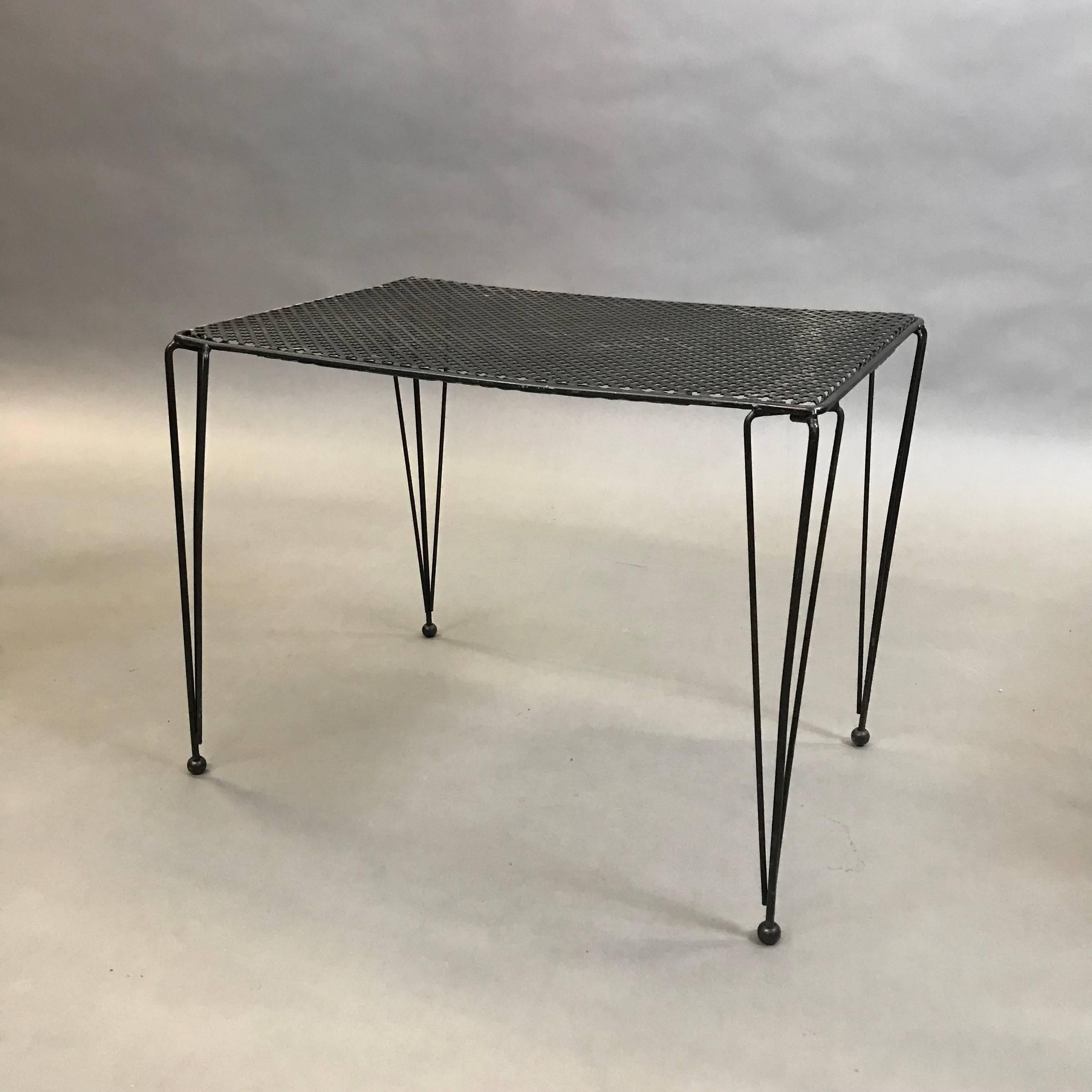 Mid-Century Modern, wrought iron side table features wonderfully detailed, slender legs and patterned mesh top. Can be used as an indoor and outdoor table.