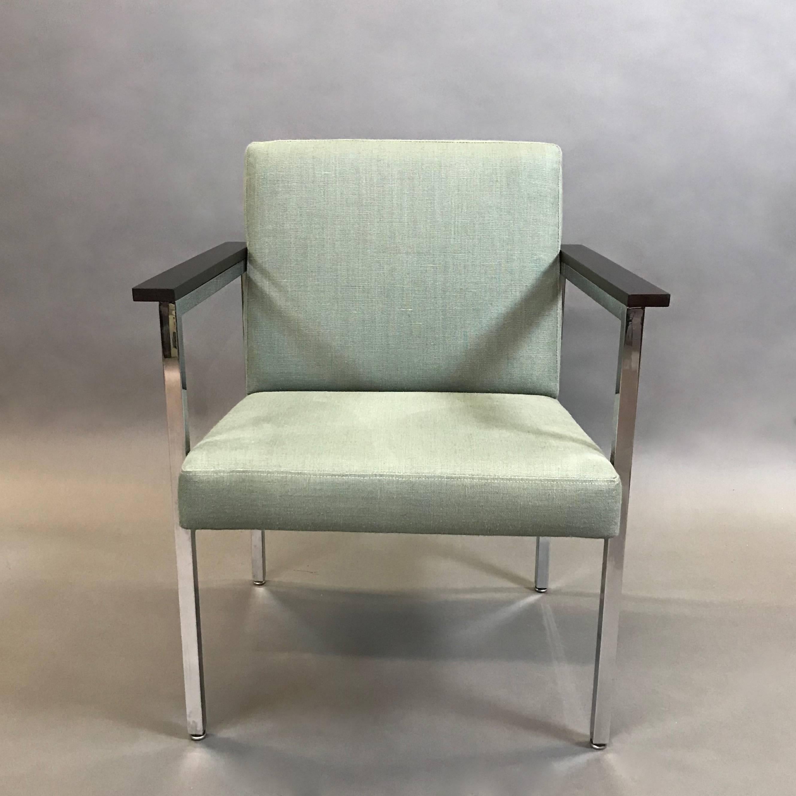 Mid-Century Modern, 1970s, chrome framed armchair features ebonized maple armrests and newly upholstered seat and back in a moss green, cotton linen blend.