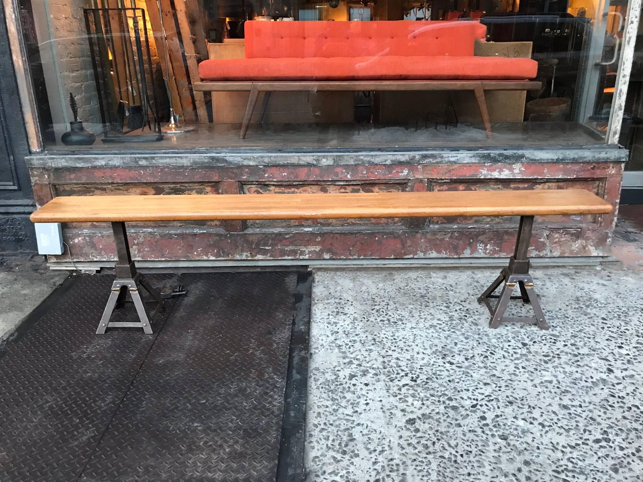 Custom, Industrial, long bench features a reclaimed oak top with vintage, 1920s, cast iron jack legs that are height adjustable from 14 in – 21.5 in.

  
