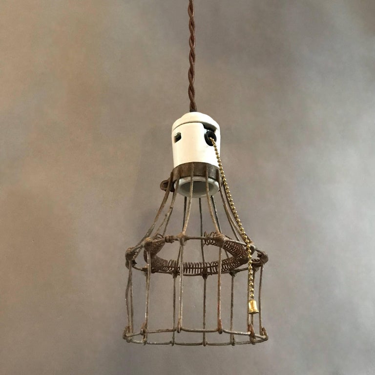 Early 20th Century Industrial Porcelain and Steel Wire Cage Pendant Lights For Sale