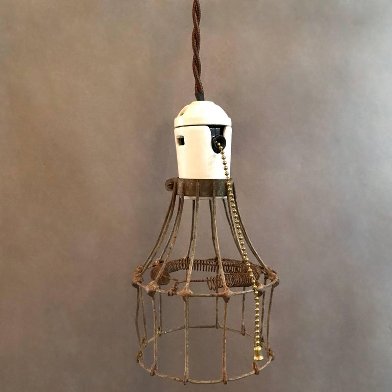 Industrial Porcelain and Steel Wire Cage Pendant Lights In Good Condition For Sale In Brooklyn, NY
