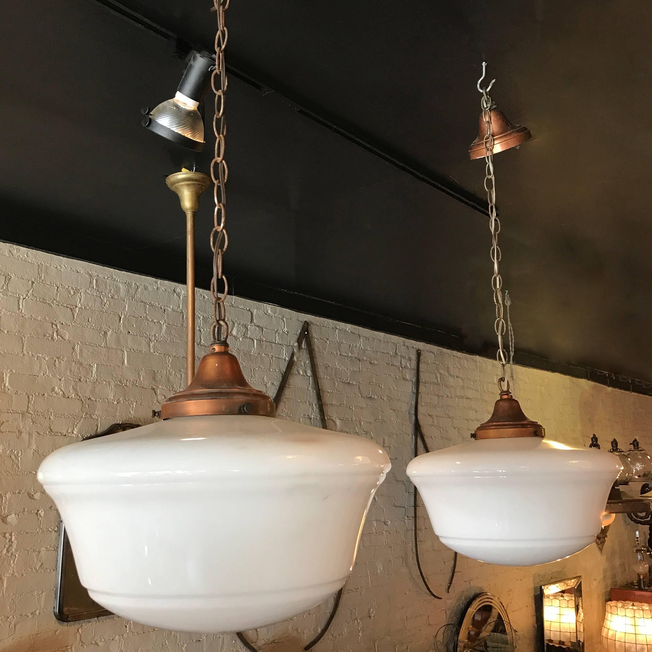 Pair of Art Deco, library pendant lights feature milk glass shades with copper fitters, 36