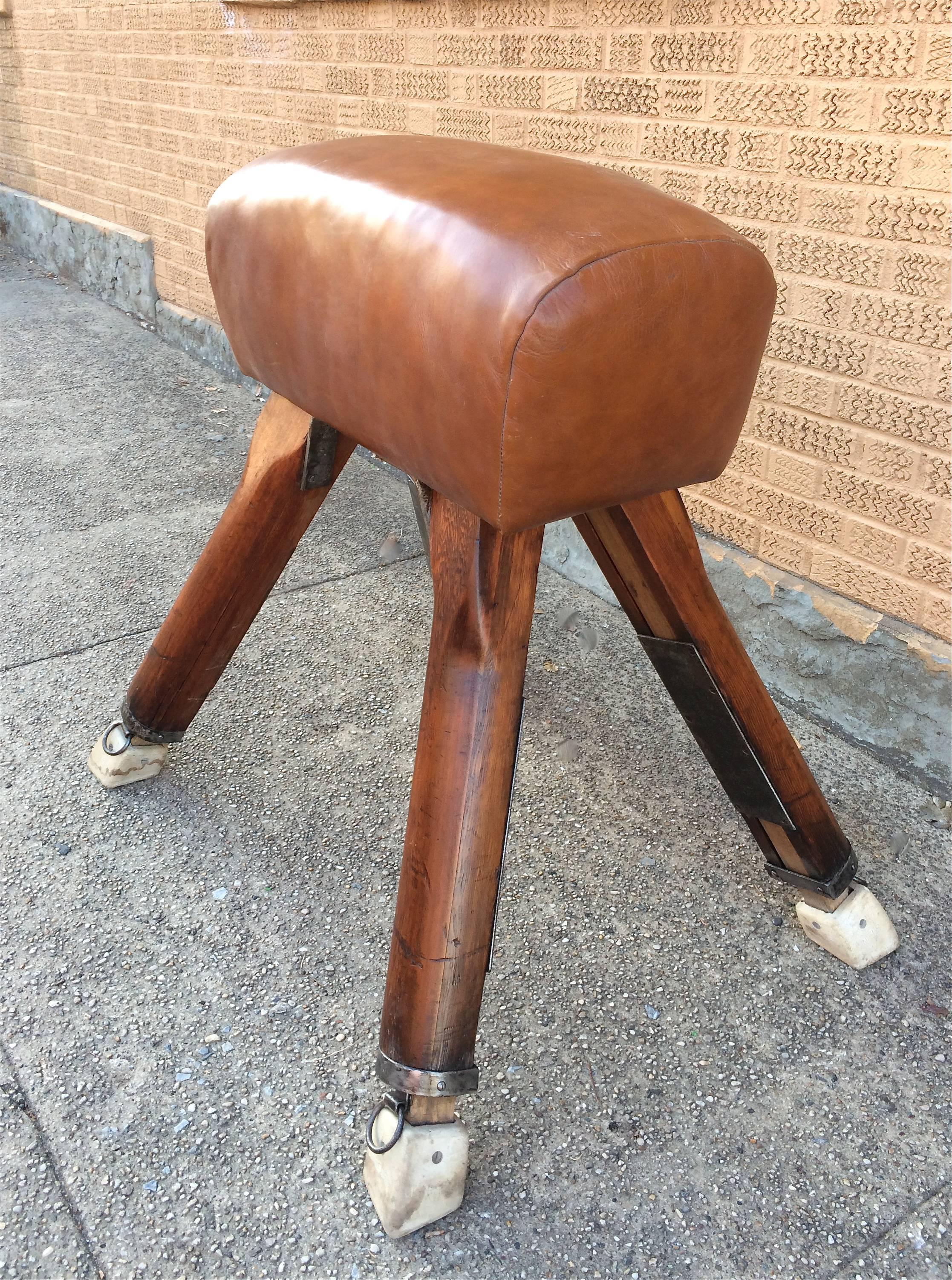 1940s, vaulting pommel horse with newly upholstered tan leather seat and oak legs by Niels Larsen, Denmark.

Measures: 37.5