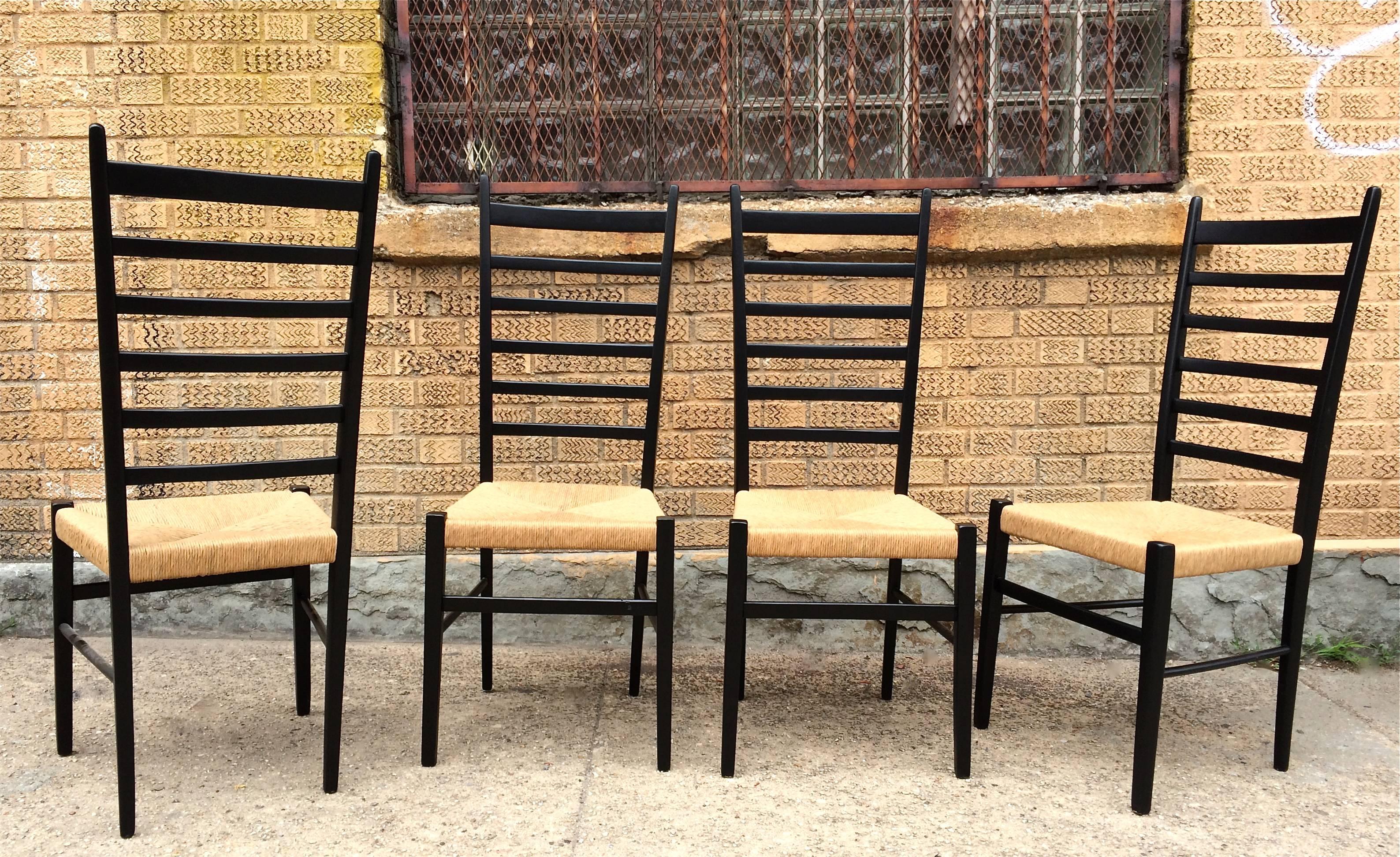 Set of four, lacquered maple, high ladder back chairs with woven rush seats attributed to Gio Ponti, marked made in Italy.
