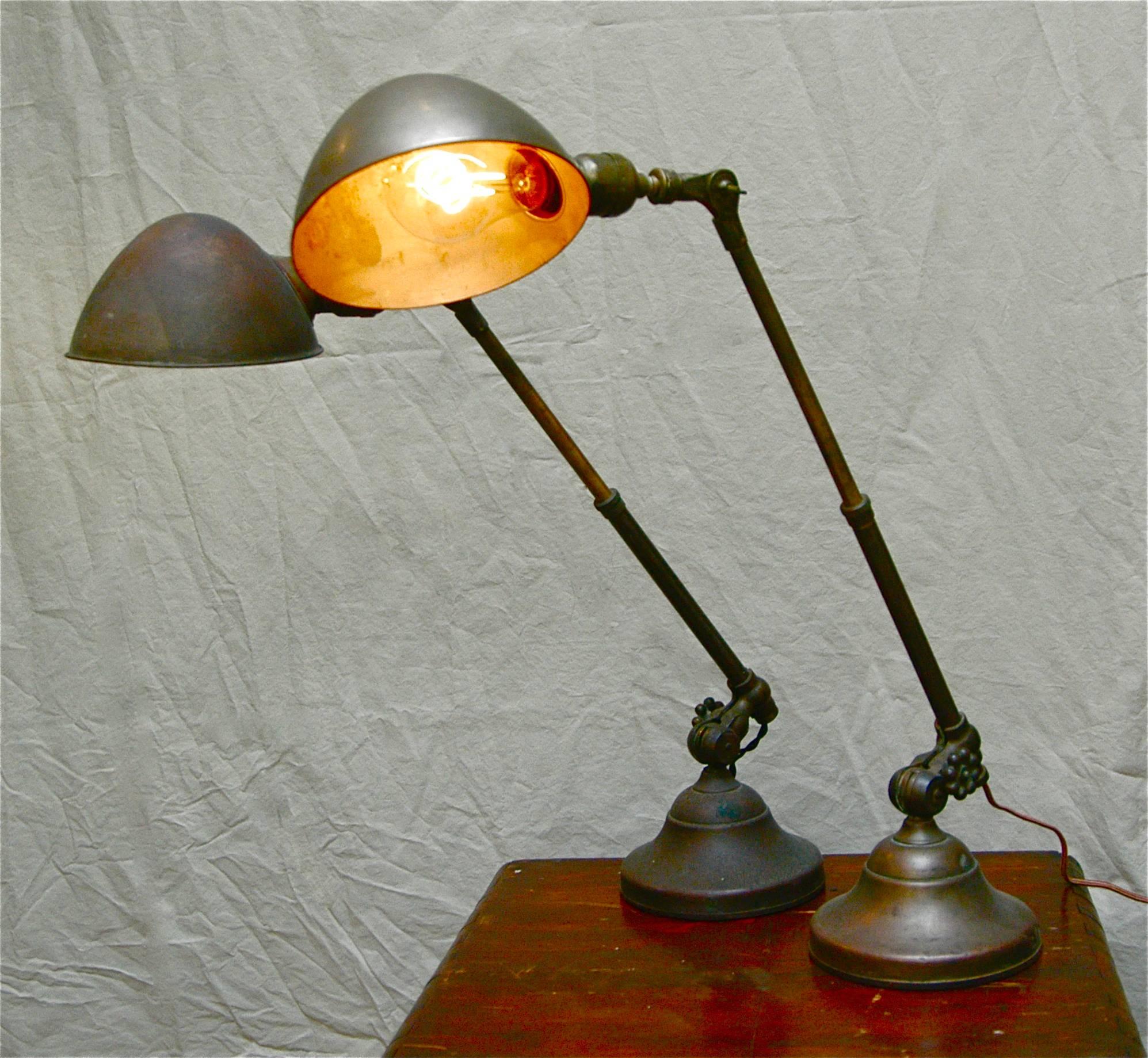 Pair of late 19th century, O.C. White, brass and steel, factory task lamps featuring extending telescopic arms. The lamps adjust from 15
