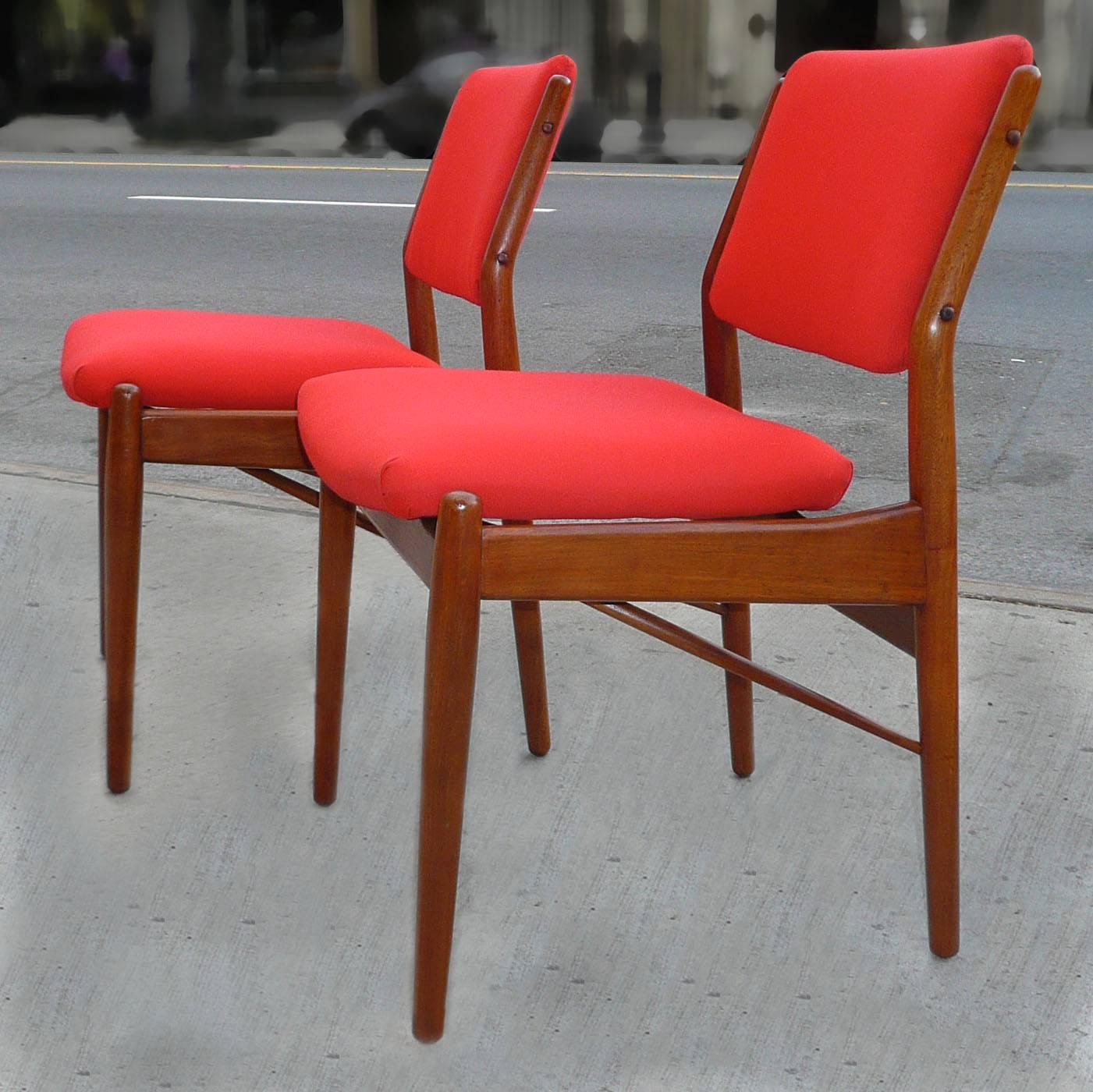 Set of four teak, Danish modern, teak dining chairs by Finn Juhl are newly upholstered in Kravet’s Soleil Tomato linen fabric.