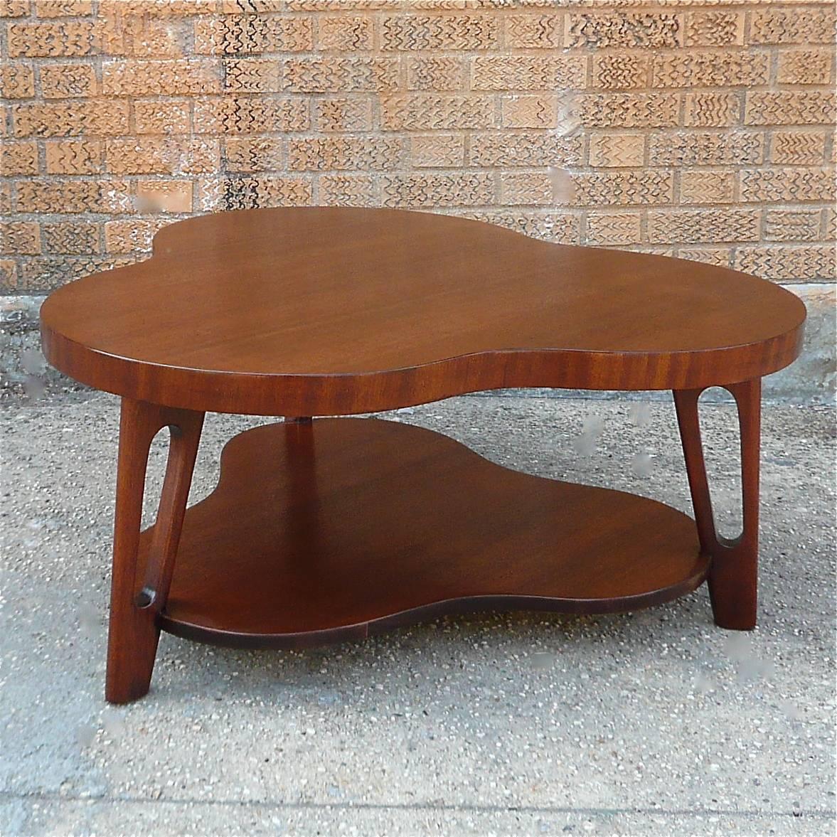 Exceptional, Mid-Century Modern, two-tiered, mahogany, clover shaped coffee table attributed to Gilbert Rohde, looks fantastic from every angle.