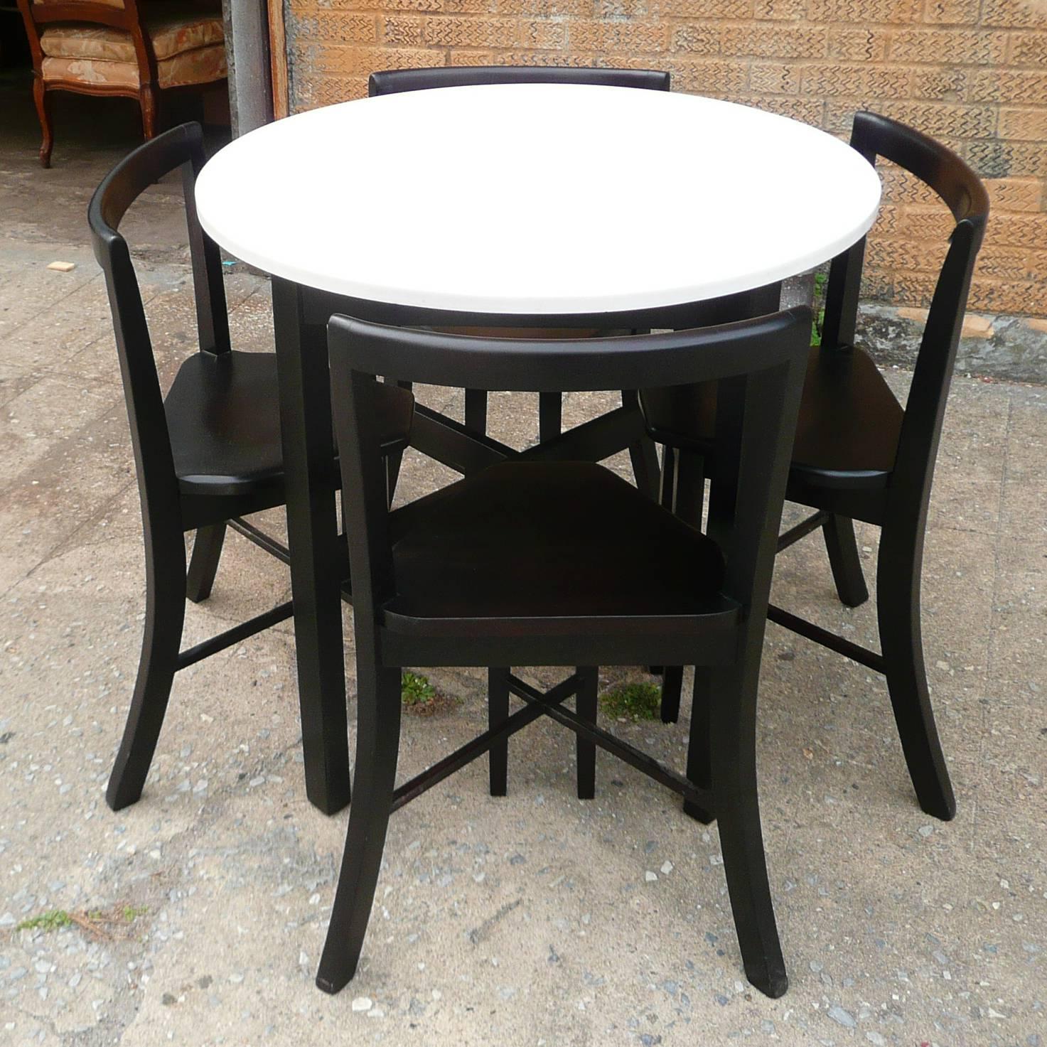1940s, round dining set includes table with white Vitrolite glass top and black lacquered wood frame and 4 matching wood chairs that contour to fit the table

Table: 31