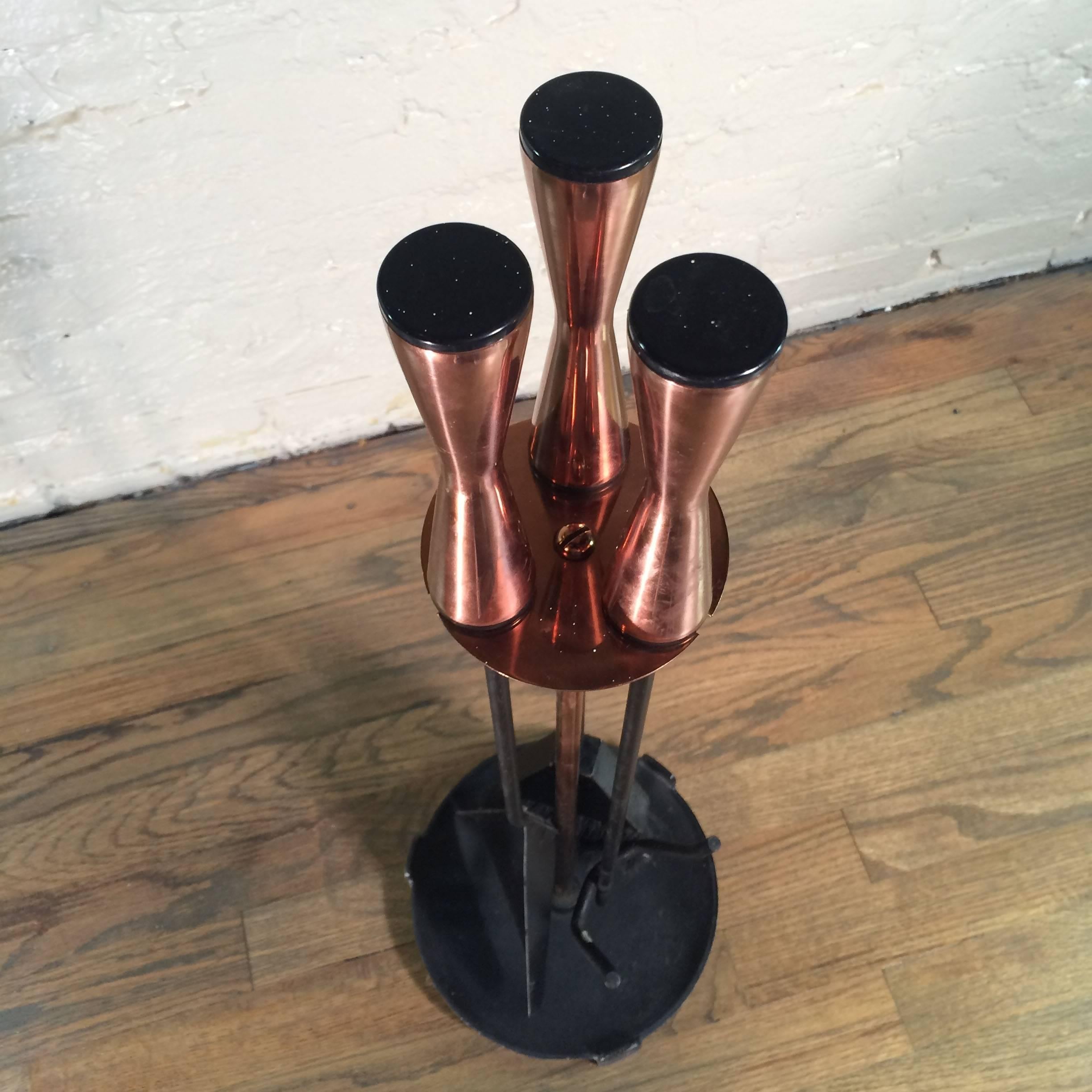 Mid-century modern, four-piece set of wrought iron fireplace tools with contoured copper handles and middle stem of holder