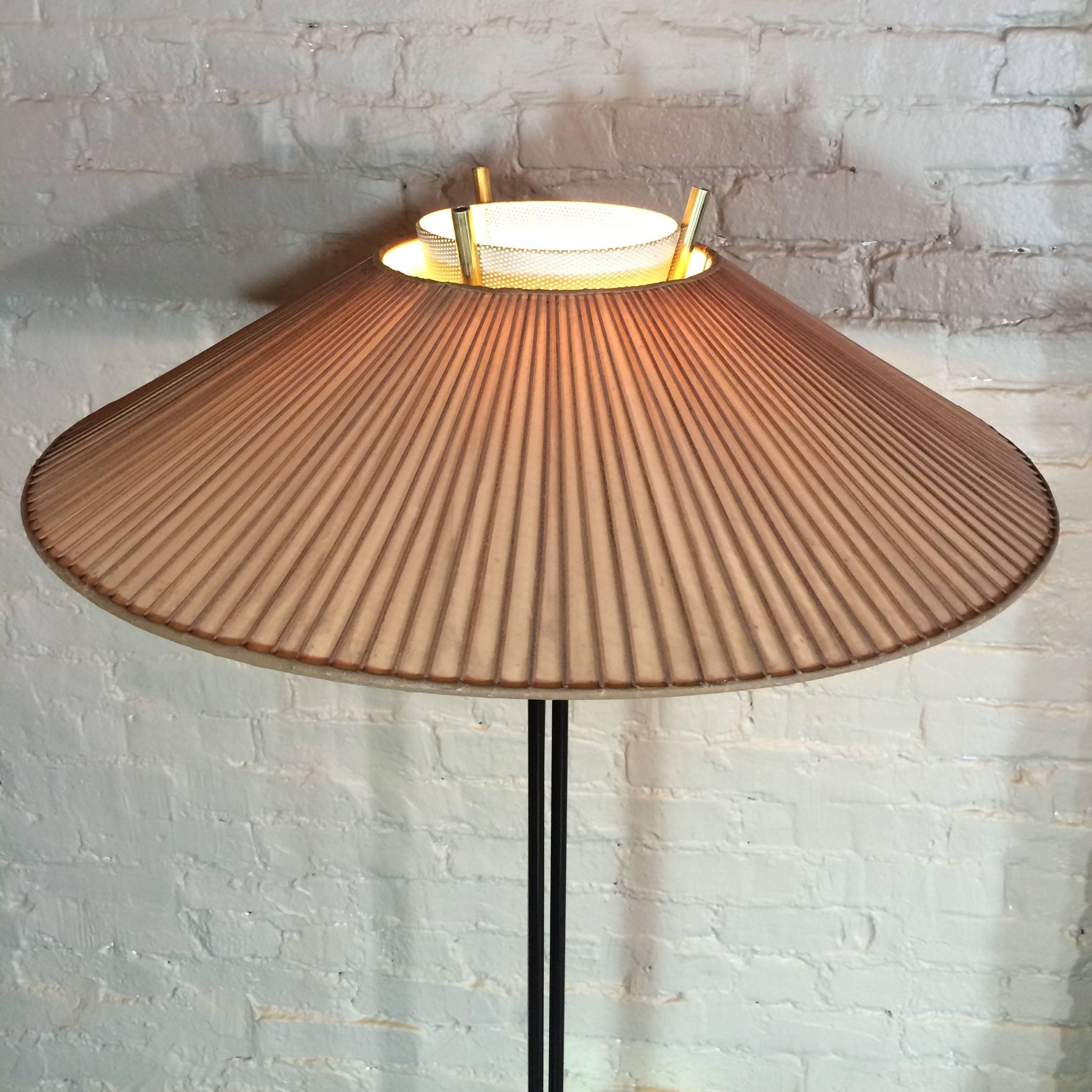 Mid-Century Modern floor lamp by Gerald Thurston for Lightolier mixes brass with perforated steel with original slatted bamboo shade. Diameter of shade 25 inches.