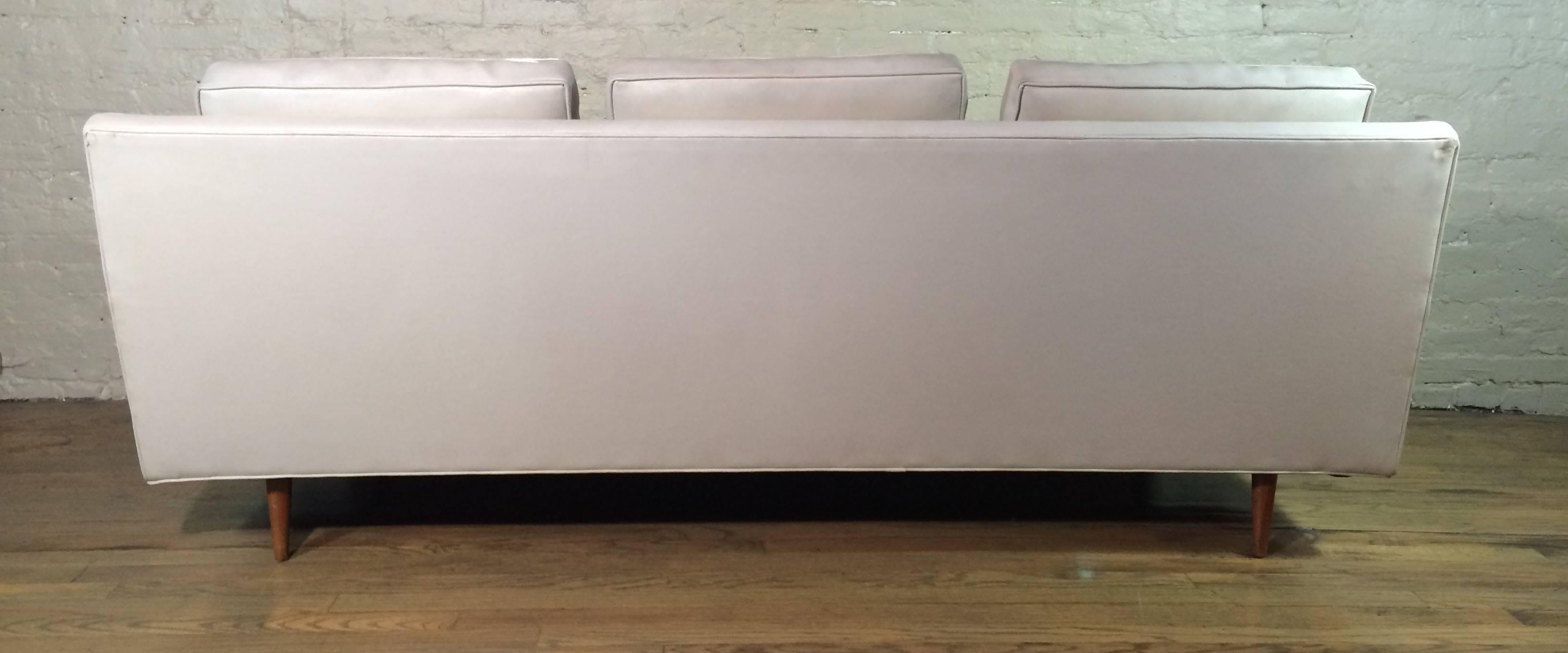 Mid-Century Modern sofa by Milo Baughman for Thayer Coggin is upholstered in a pale gray vinyl with birch legs.