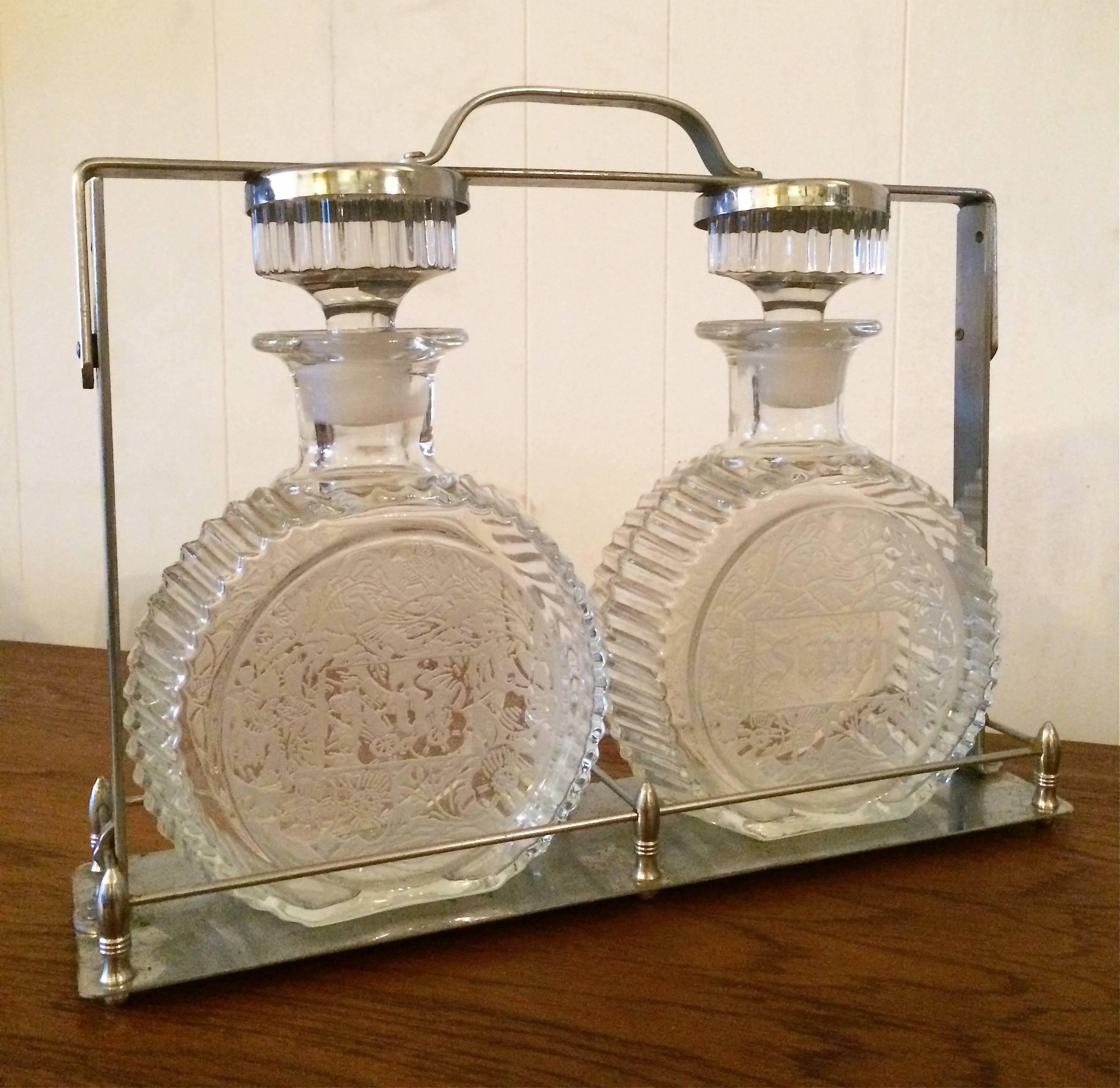 Crystal liquor tantalus decanter set has two, cut, acid etched, crystal decanters marked Scotch and Rye in a chrome caddy.

Frame is 13.5