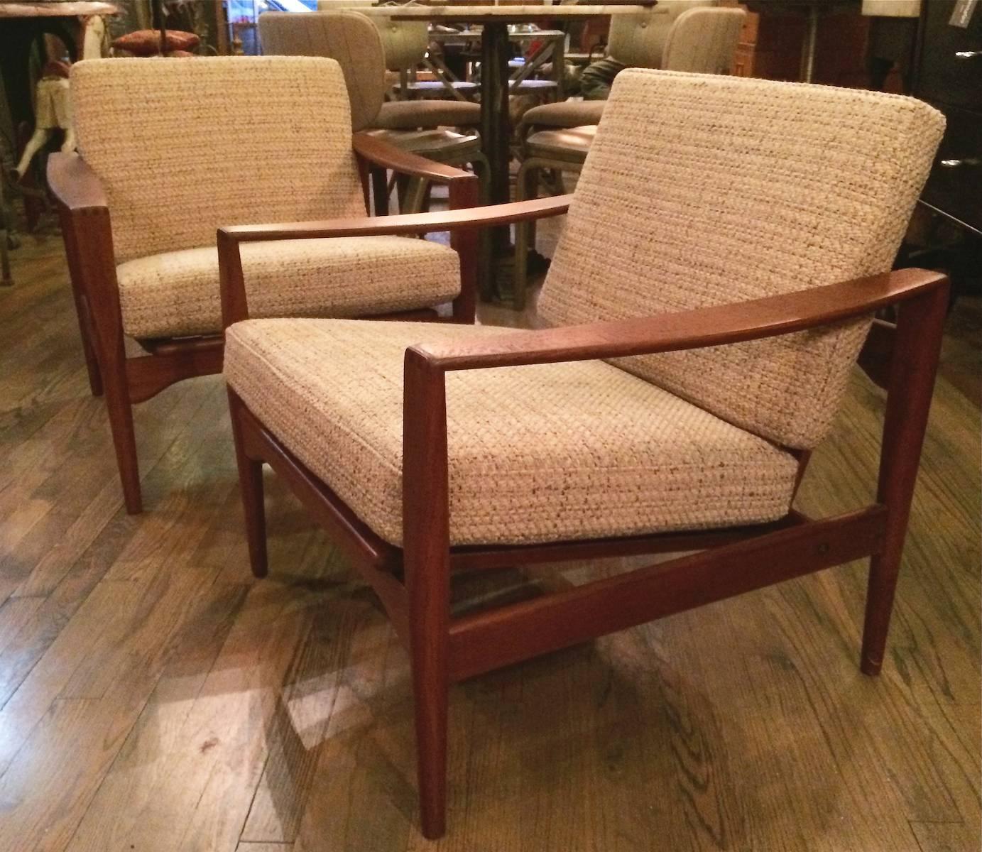 Pair of Danish modern, teak frame lounge chairs by Arne Wahl Iversen are newly restored with cushions upholstered in a nicely contrasting oatmeal wool blend.