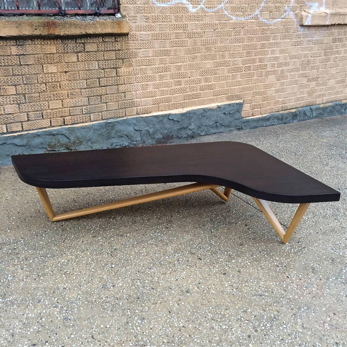 Mid-Century Modern, low, boomerang shape, coffee table with ebonized mahogany top and sculptural natural ash legs.