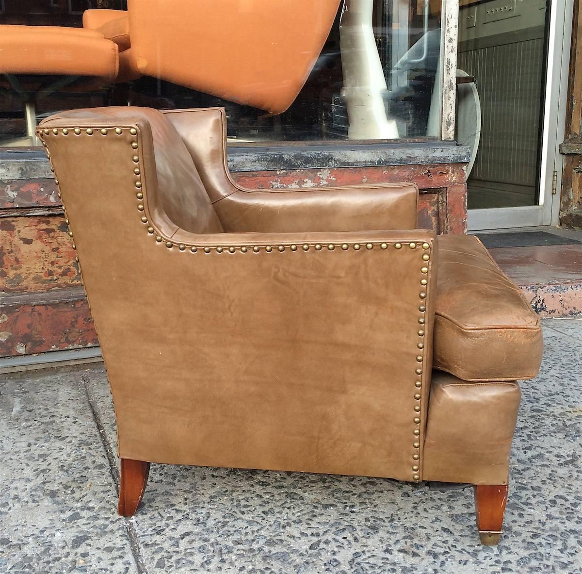Mid-Century, 1940s, deep, low profile, tan leather club chair with nail head trim and mahogany legs is weathered nicely in original condition made by Hickory Chair Company, NC.