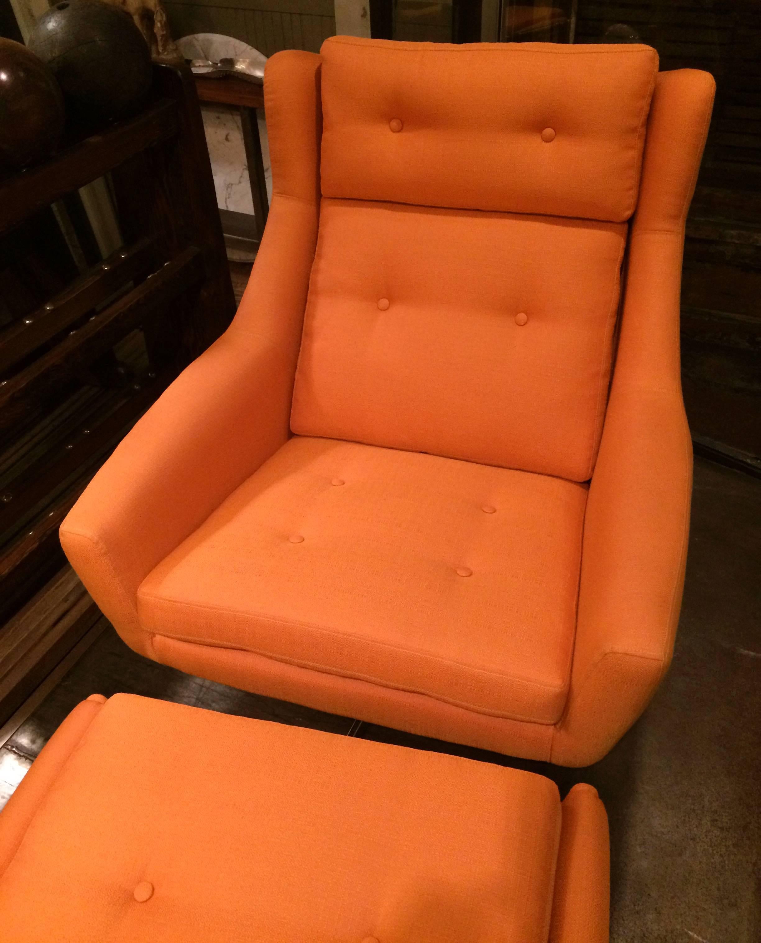 1950s, Mid-Century Modern, upholstered, reclining lounge chair that swivels on a chrome four prong base with matching ottoman attributed to John Stuart. Marked Made In Denmark. Both pieces are newly upholstered in a striking tangerine linen