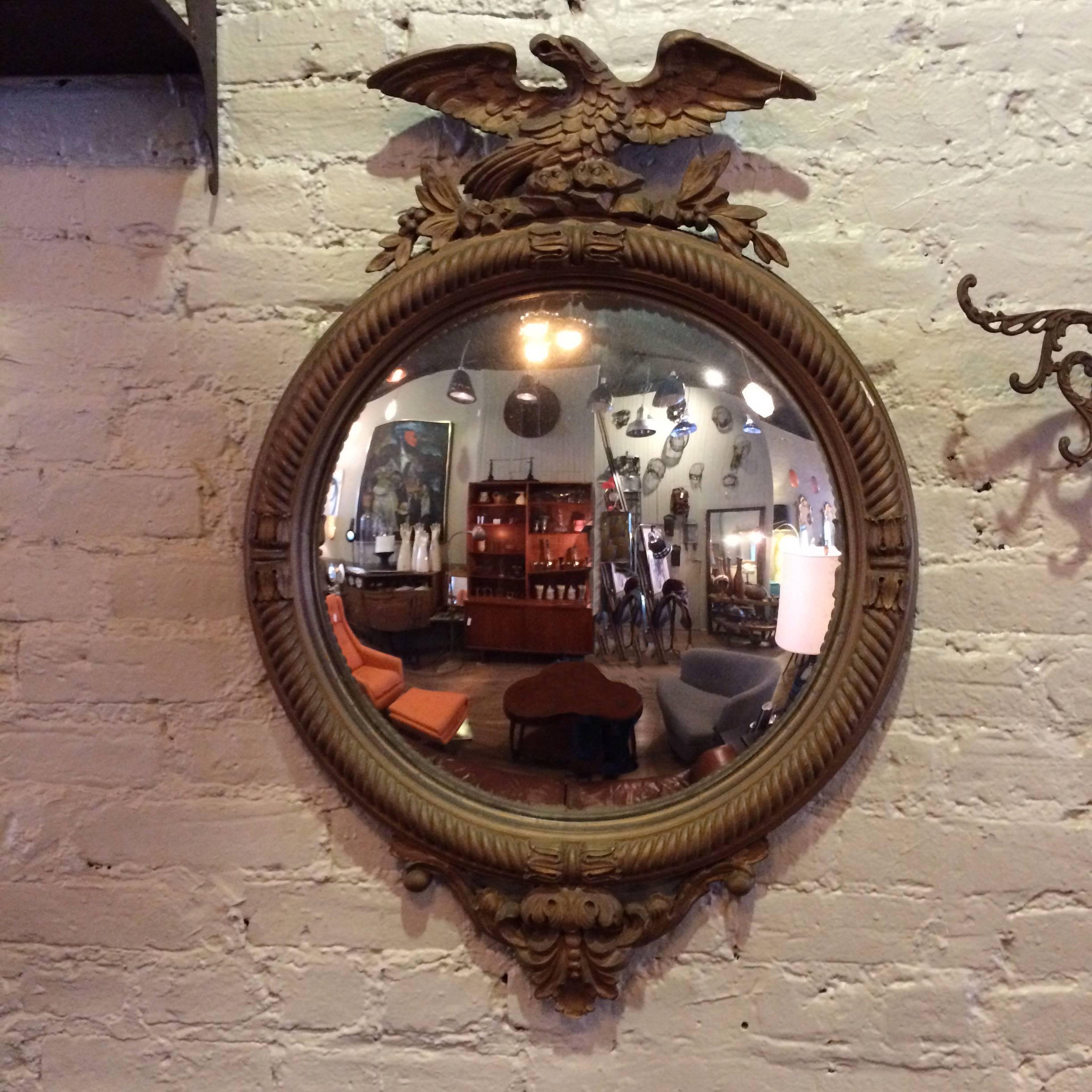 1930s, Federal style, convex mirror with perched eagle atop a matte giltwood and gesso frame.