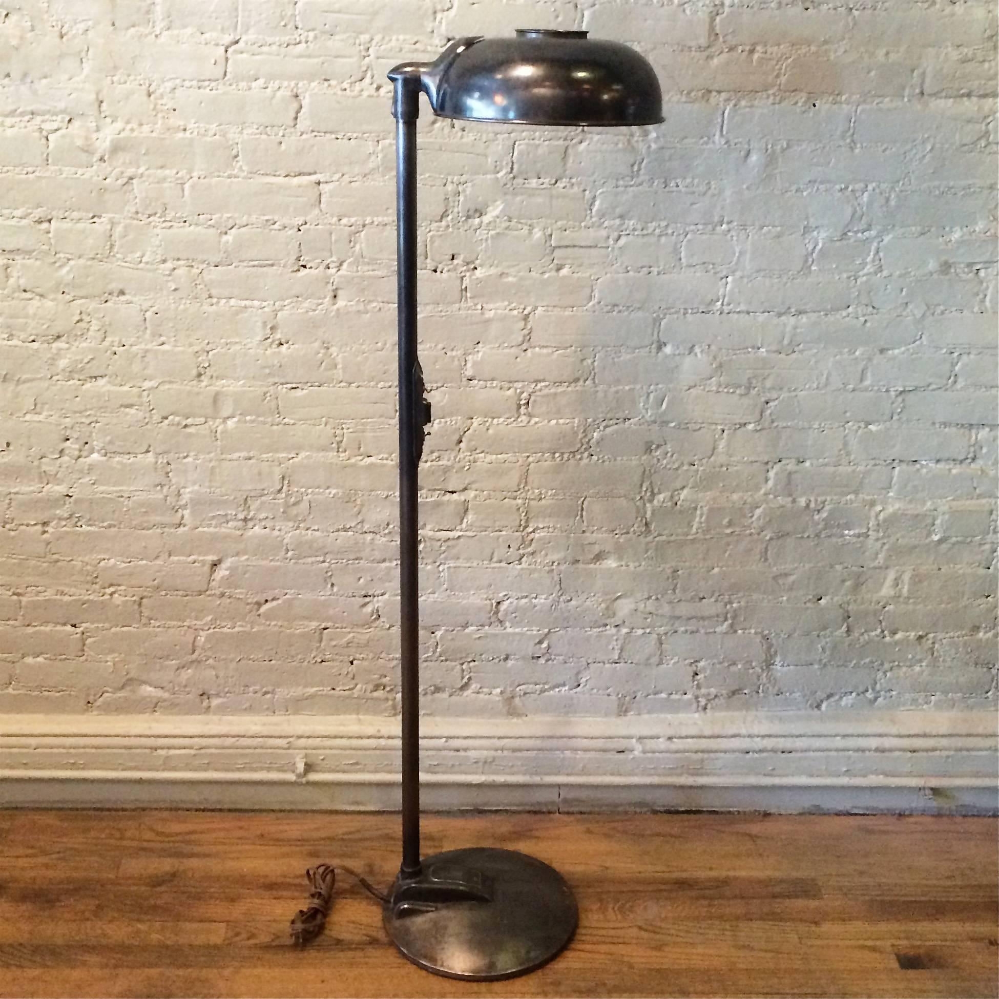 1930s, streamlined, Industrial, Machine Age, medical floor lamp with articulating shade is steel in a gunmetal finish. The lamp takes a regular bulb up to 200 watts.