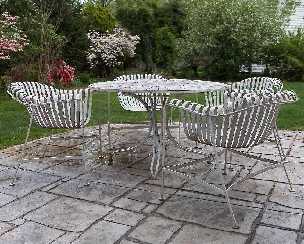 Mid-Century Modern, painted wrought iron, garden, patio, dining set with round, sunburst table and four slatted armchairs attributed to Russell Woodard 