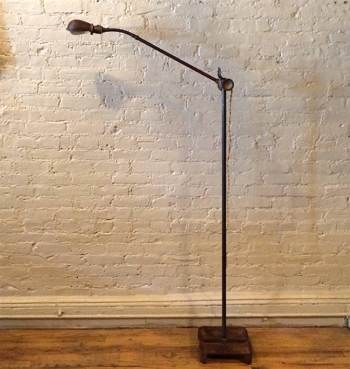 Rare, 1930s industrial, steel floor lamp by Phillips Sears Co. with height adjustable and articulating, gooseneck arm with cast iron tray base.