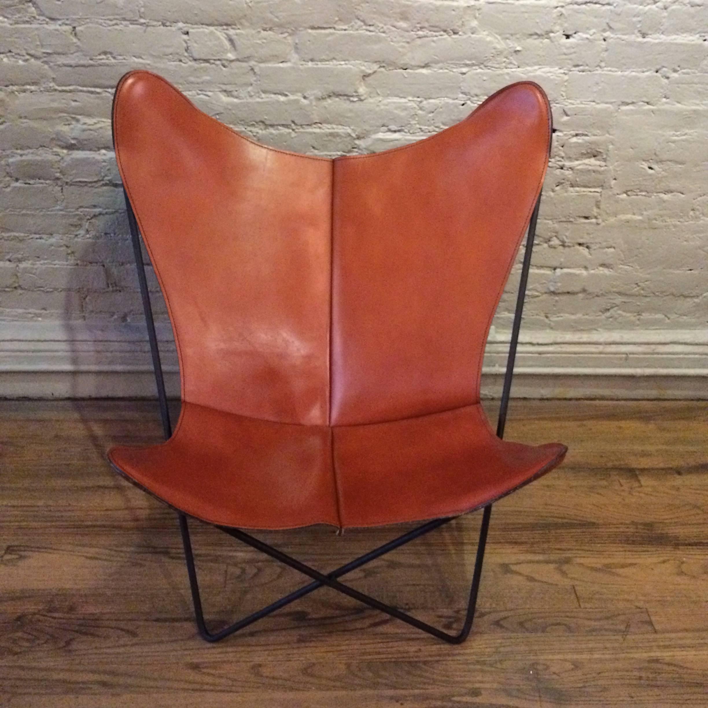 Mid-Century Modern, butterfly chair designed by Jorge Ferrari-Hardoy for Knoll with wrought iron base and cognac leather seat. The base is newly painted and the leather is in excellent original condition.