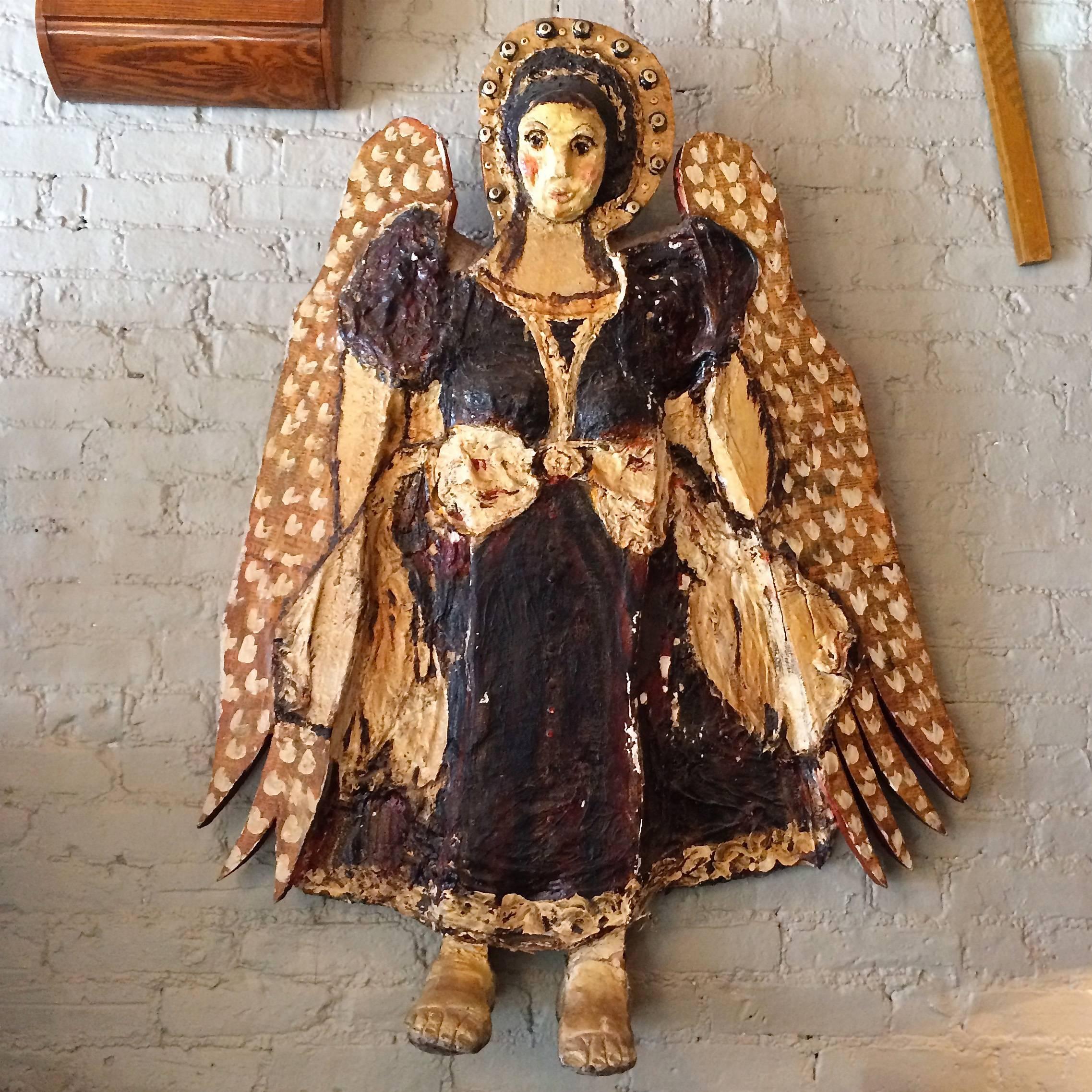 Large, mixed media, Folk Art angel is plaster sculpture with acrylic paint on wood cutout with newspaper backing on her wings. The angel is signed and dated 1968 by the Danish born artist. This artist's work also includes our listing of the Large