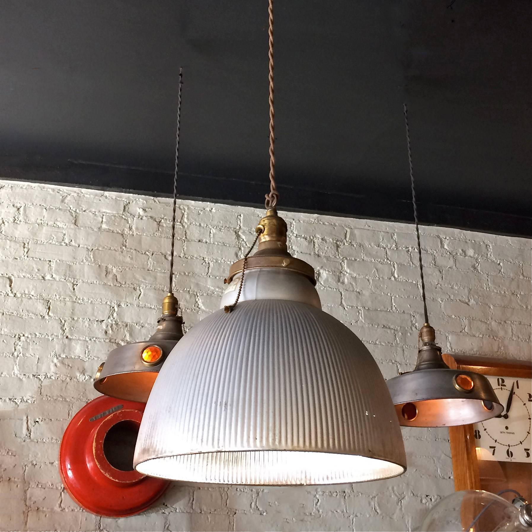 Industrial pendant light features a silver, X-ray, mercury glass dome shade with brass pull chain fitter is newly wired with 72