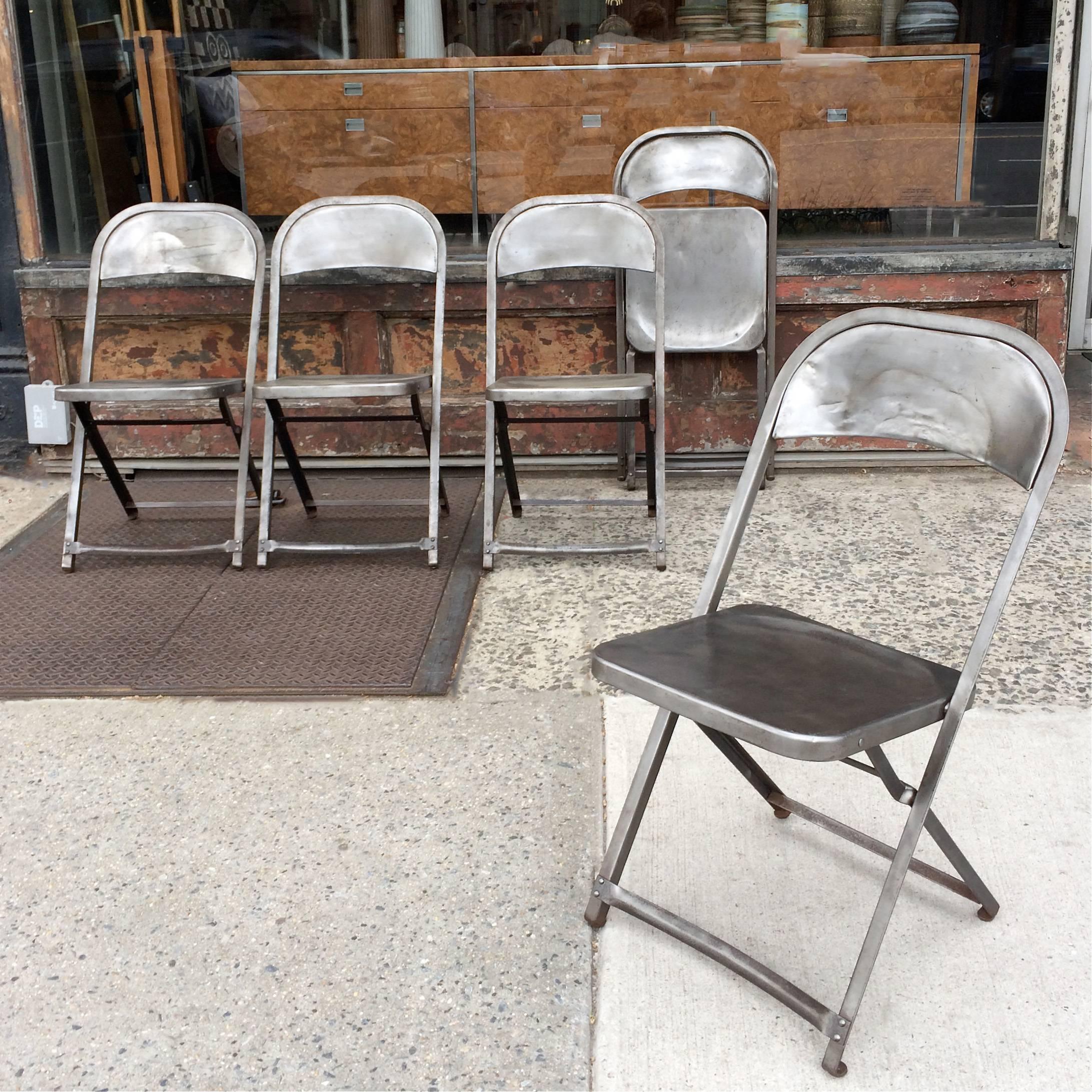 Set of five, Industrial, brushed steel, folding chairs are newly finished and sealed.