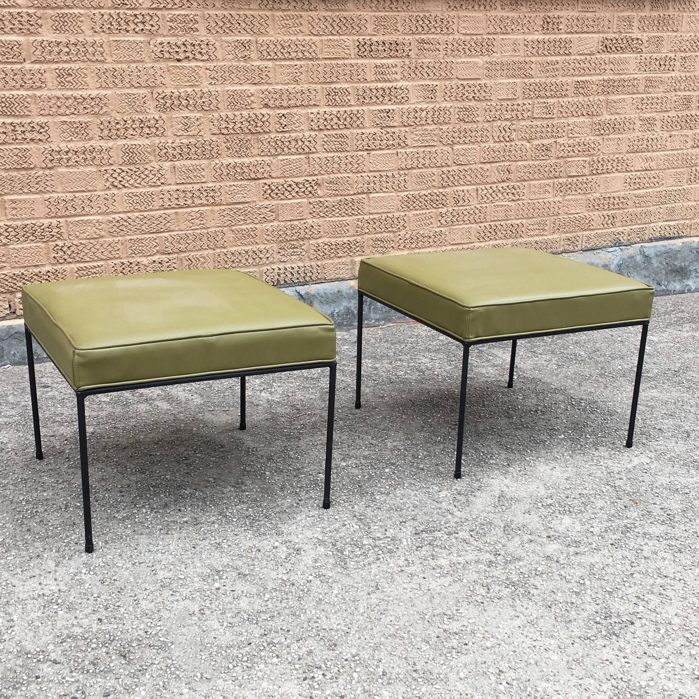 Pair of Mid-Century Modern, low-profile, ottomans or benches by Paul McCobb feature square wrought iron frames and newly upholstered olive green vinyl seats.