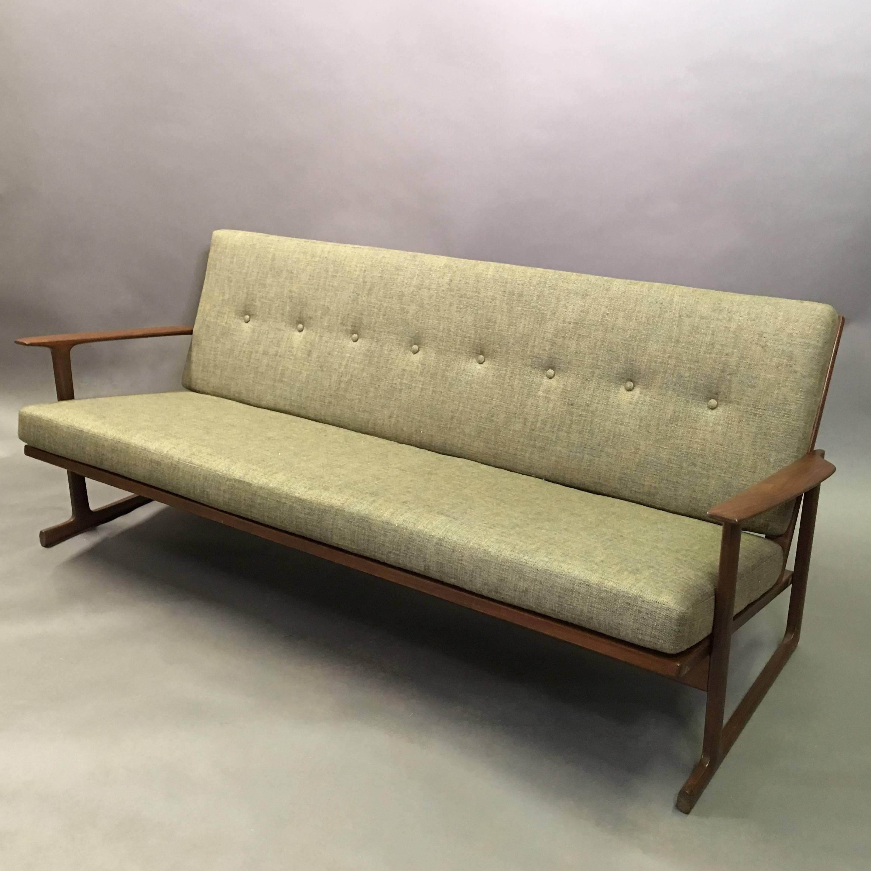 Midcentury, Danish modern, sofa designed by Ib Kofod-Larsen for Selig features a distinct, solid teak frame with lattice back and sleigh leg base, with newly upholstered cushions in a heather green cotton linen blend.