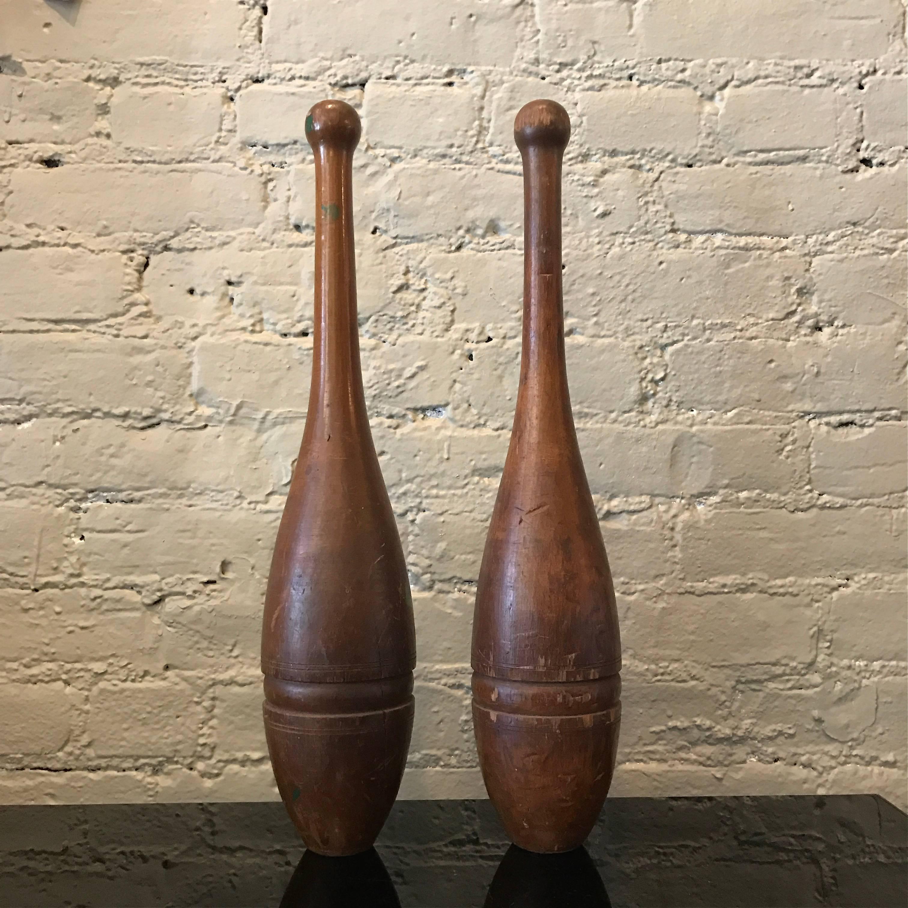 Pair of early 20th century, hand-turned, incised, stained maple wood, juggling pins or 