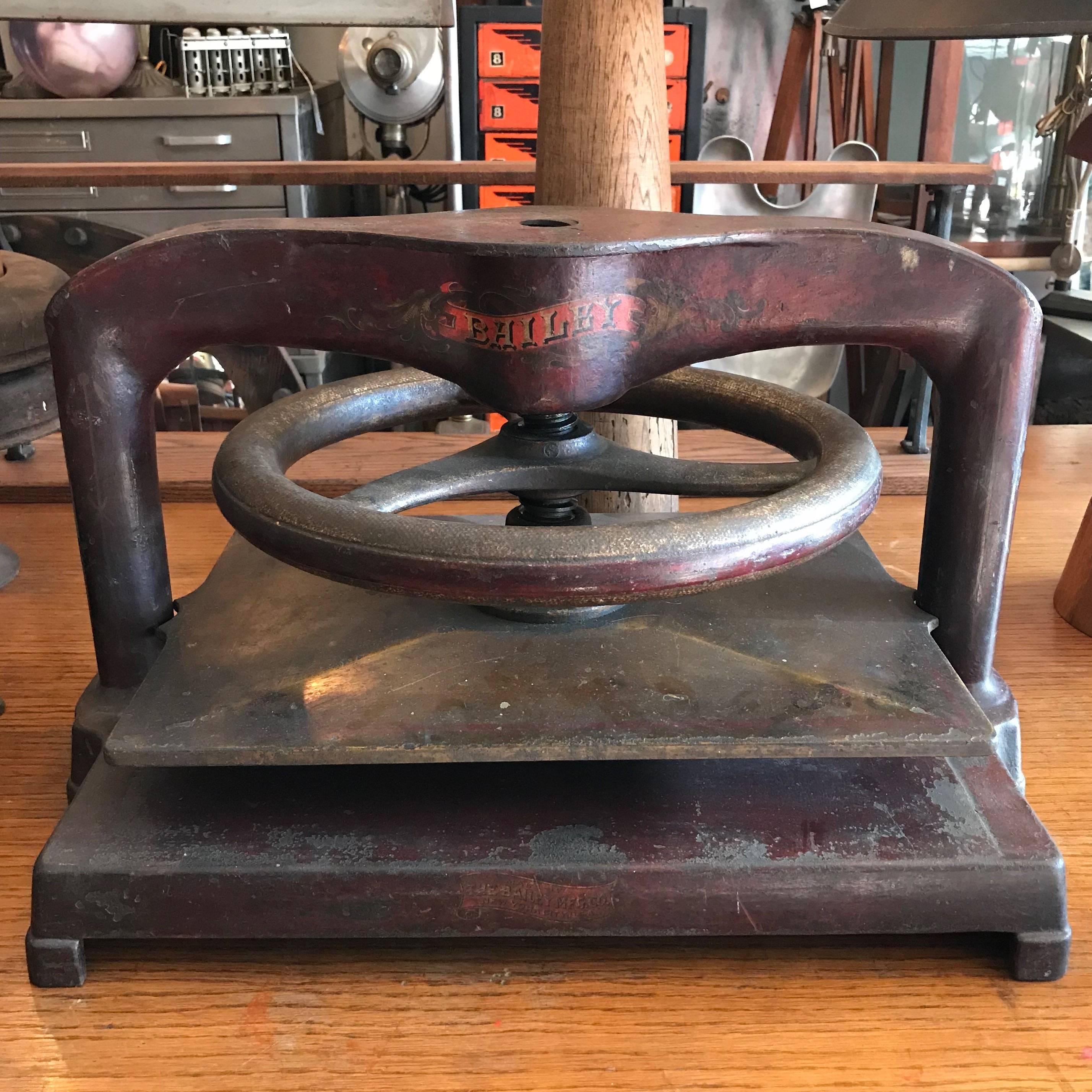 Late 19th century, large, cast iron, letter copying machine or book press manufactured by Bailey Mfg. Co. with large press wheel, features hand-painted details in red and yellow that are aged beautifully. Gap between press plates is approximately