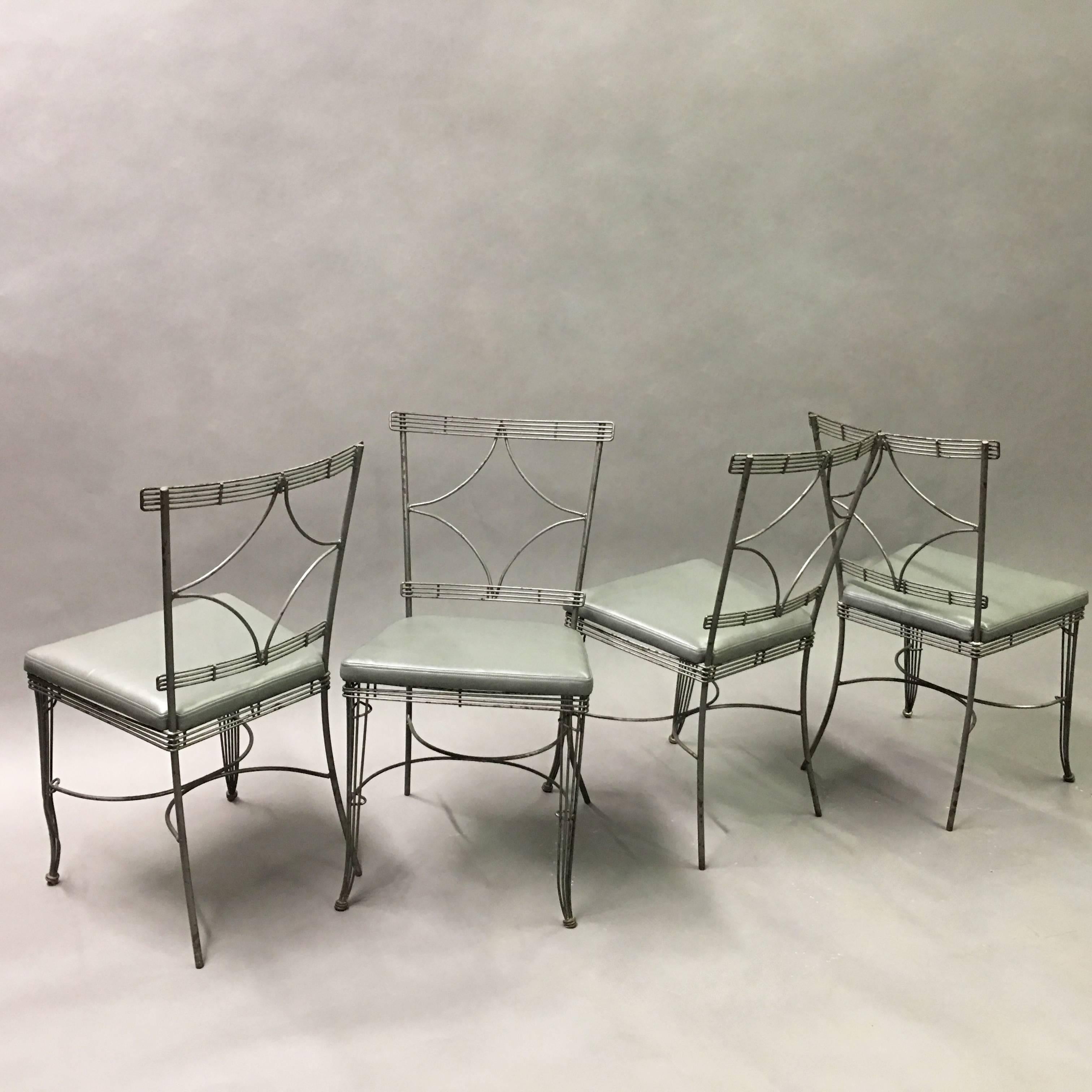 Wonderful set of four, midcentury, Hollywood Regency dining chairs feature brushed steel wire frames with diamond backs and newly upholstered seats in gray vinyl. This set is perfect for a sunroom but not recommended for outdoor use.