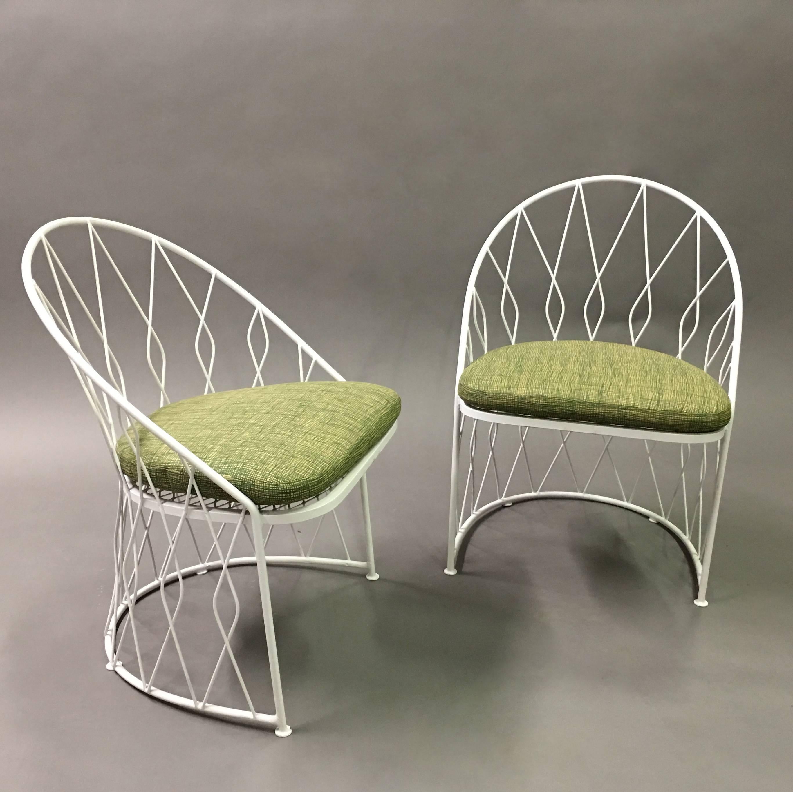 Pair of unusual, outdoor, patio, garden chairs by Salterini feature matching, woven, wrought iron backrests and bases with newly upholstered cushions. 