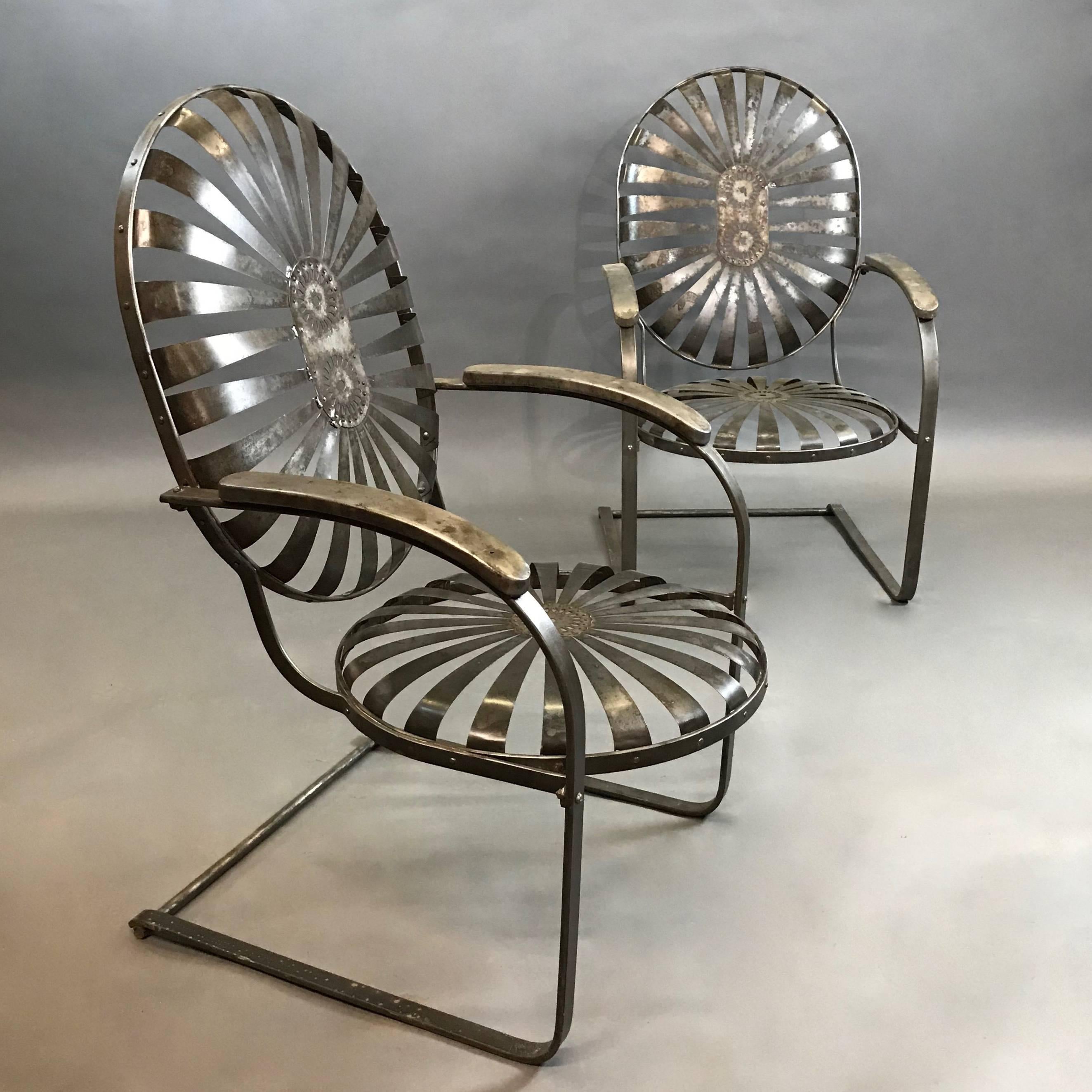Pair of French, high back, sunburst, Francois Carré armchairs with cantilever bases in a brushed steel finish. Arm height is 27 inches.