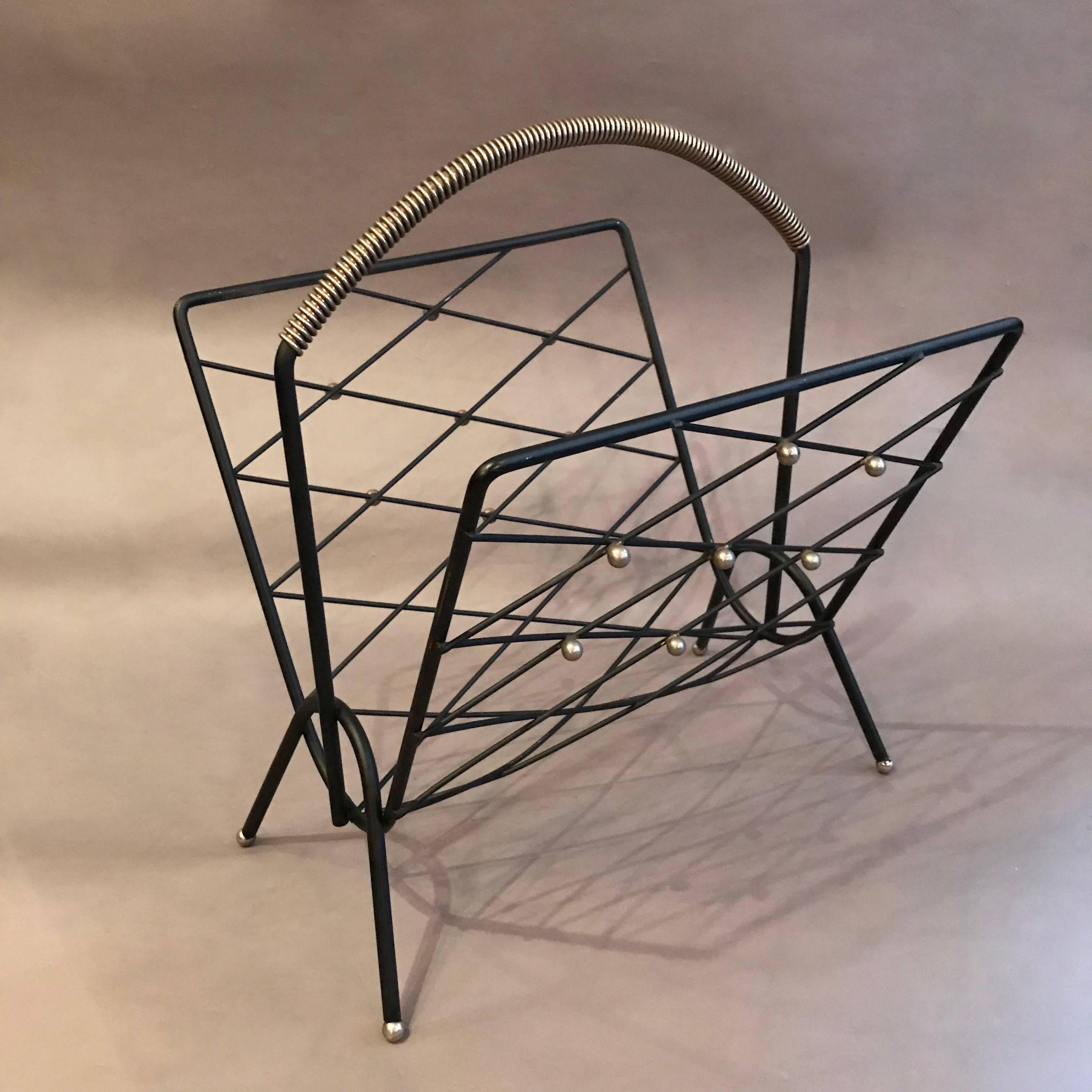 Mid-century modern magazine rack features a lattice wrought iron frame with brass ball accents. Two matching magazine racks are available.