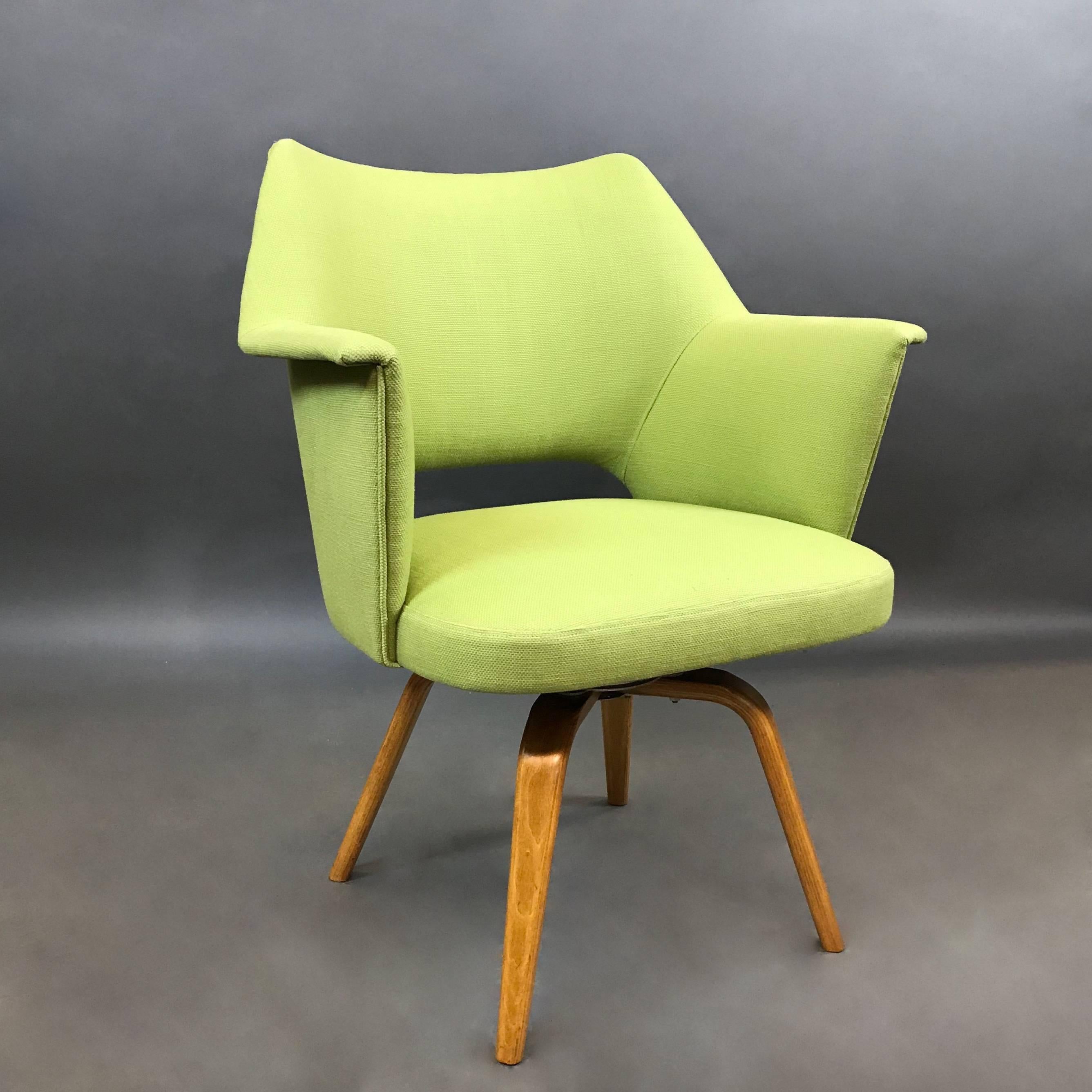 Mid-Century Modern, swivel armchair by Thonet features bright green cotton linen upholstery atop a bent maple, four leg base. Arm height is 25.5 in.