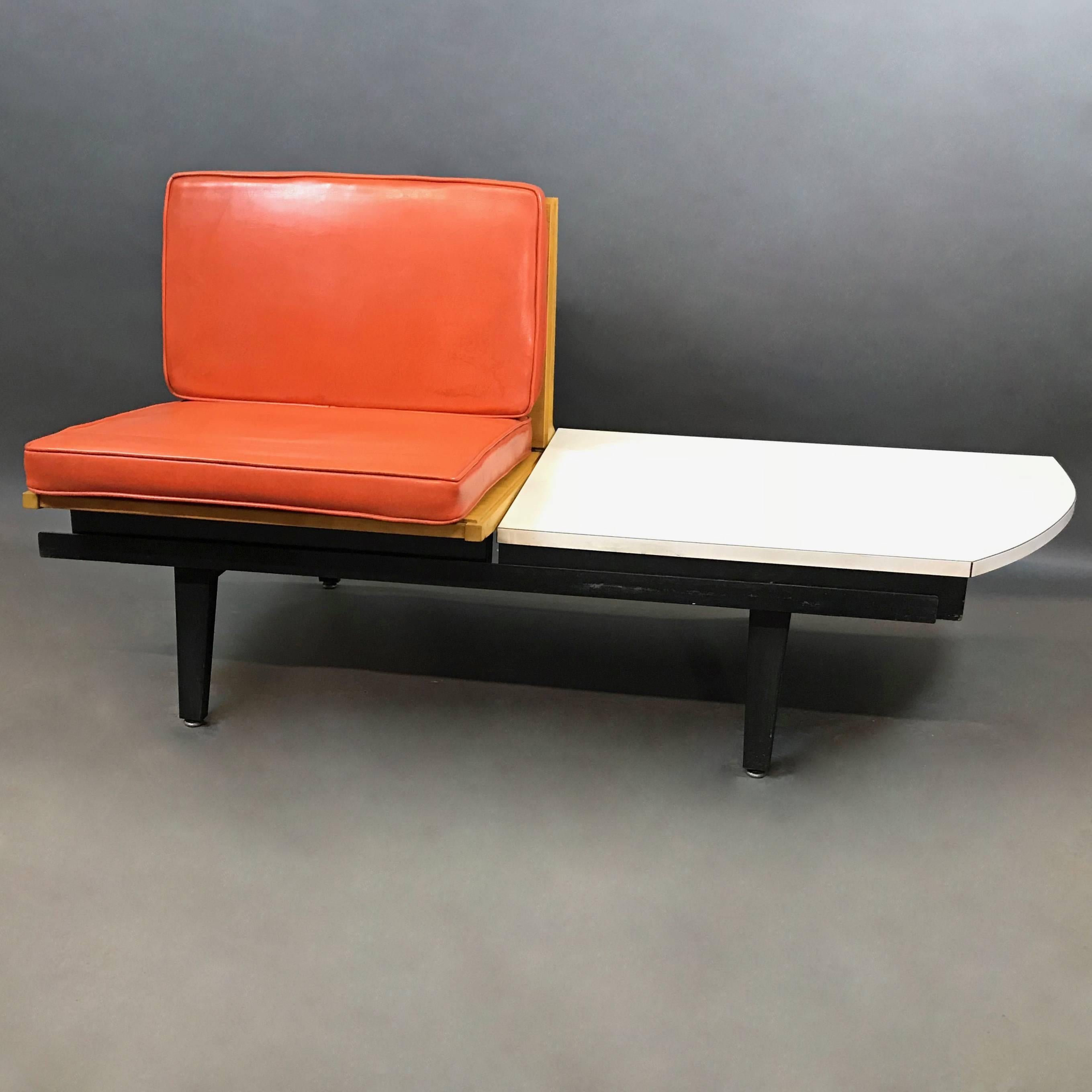 Mid-Century Modern, modular, sofa, bench seating by George Nelson for Herman Miller, steel frame collection features original, removable orange vinyl cushions on an ash seat and back with an integrated white Formica side table with rounded edge.