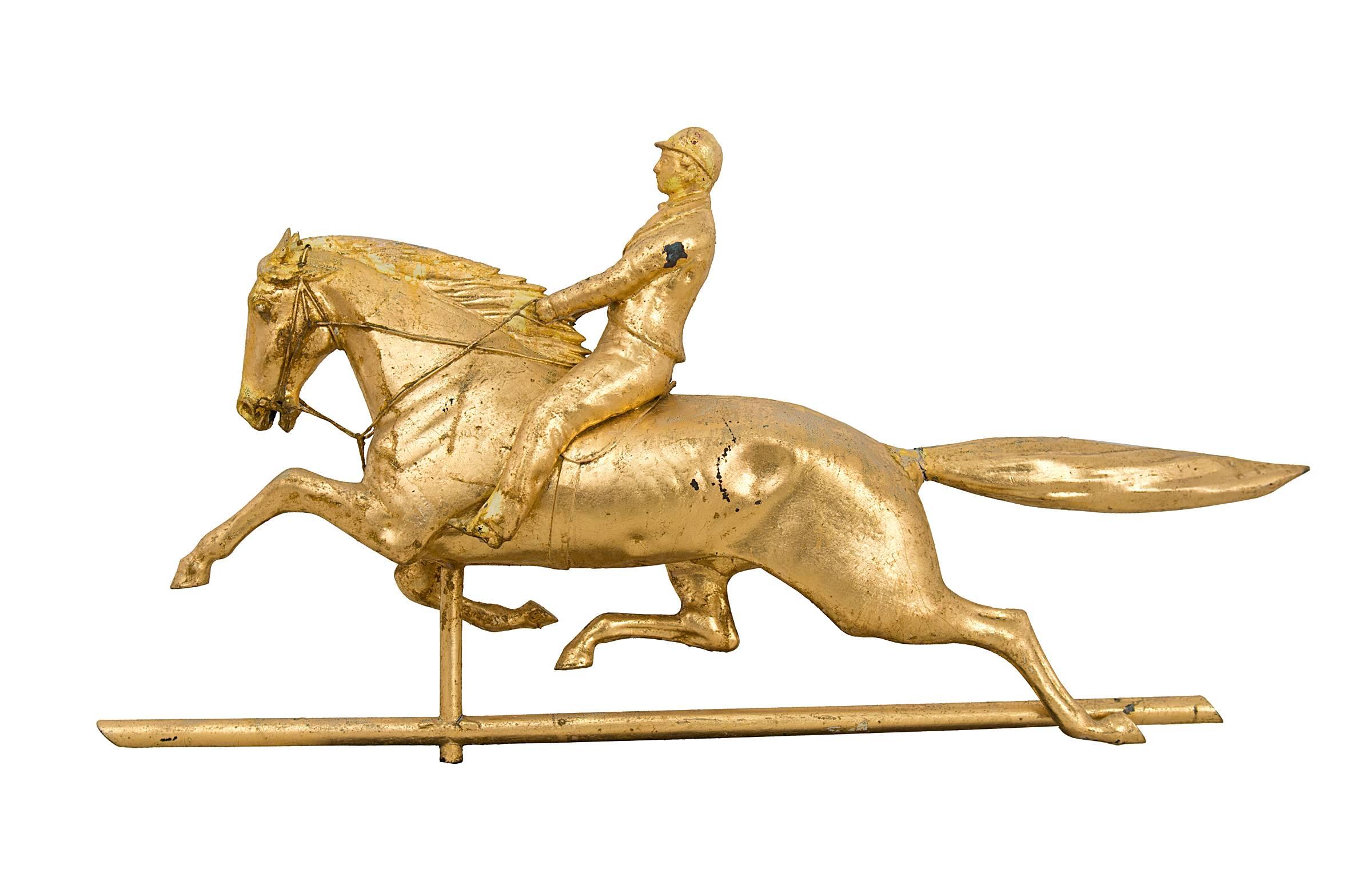 Fine horse and jockey weathervane. Molded copper and zinc. Retains an old re-gilded gold leaf surface. No structural restoration, minor crack where the tail meets the body. Attributed to Cushing and White, Waltham, Mass., circa 1875.
Complete with