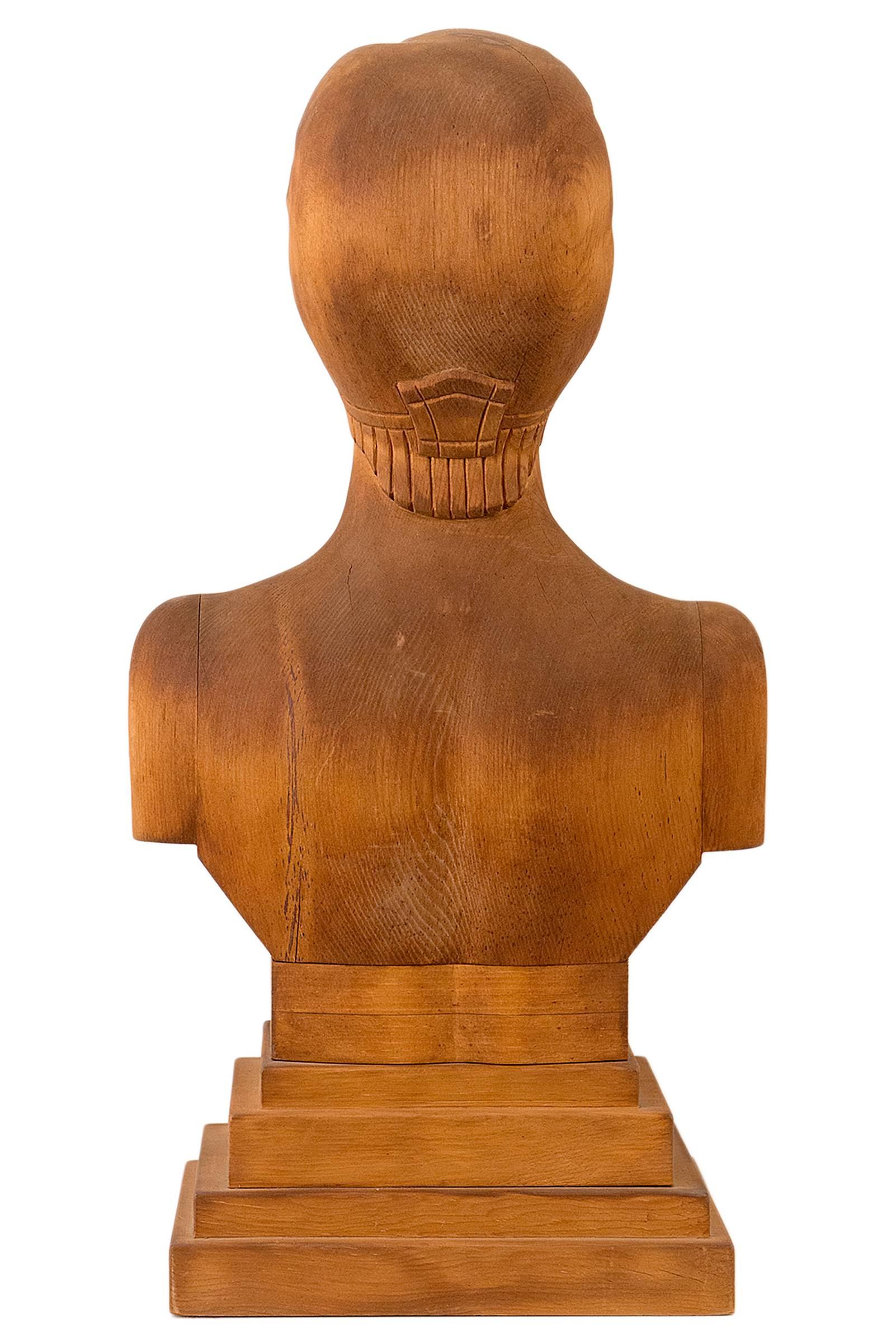 Unusual carved wooden portrait bust. A beautifully refined and reductive carving. Never painted having a natural nut brown patina.