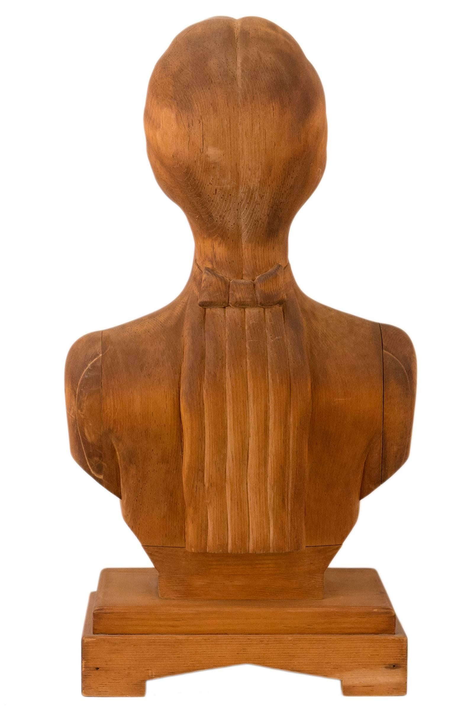 Unusual carved wooden portrait bust. A beautifully refined and reductive carving. Never painted having a natural nut brown patina.