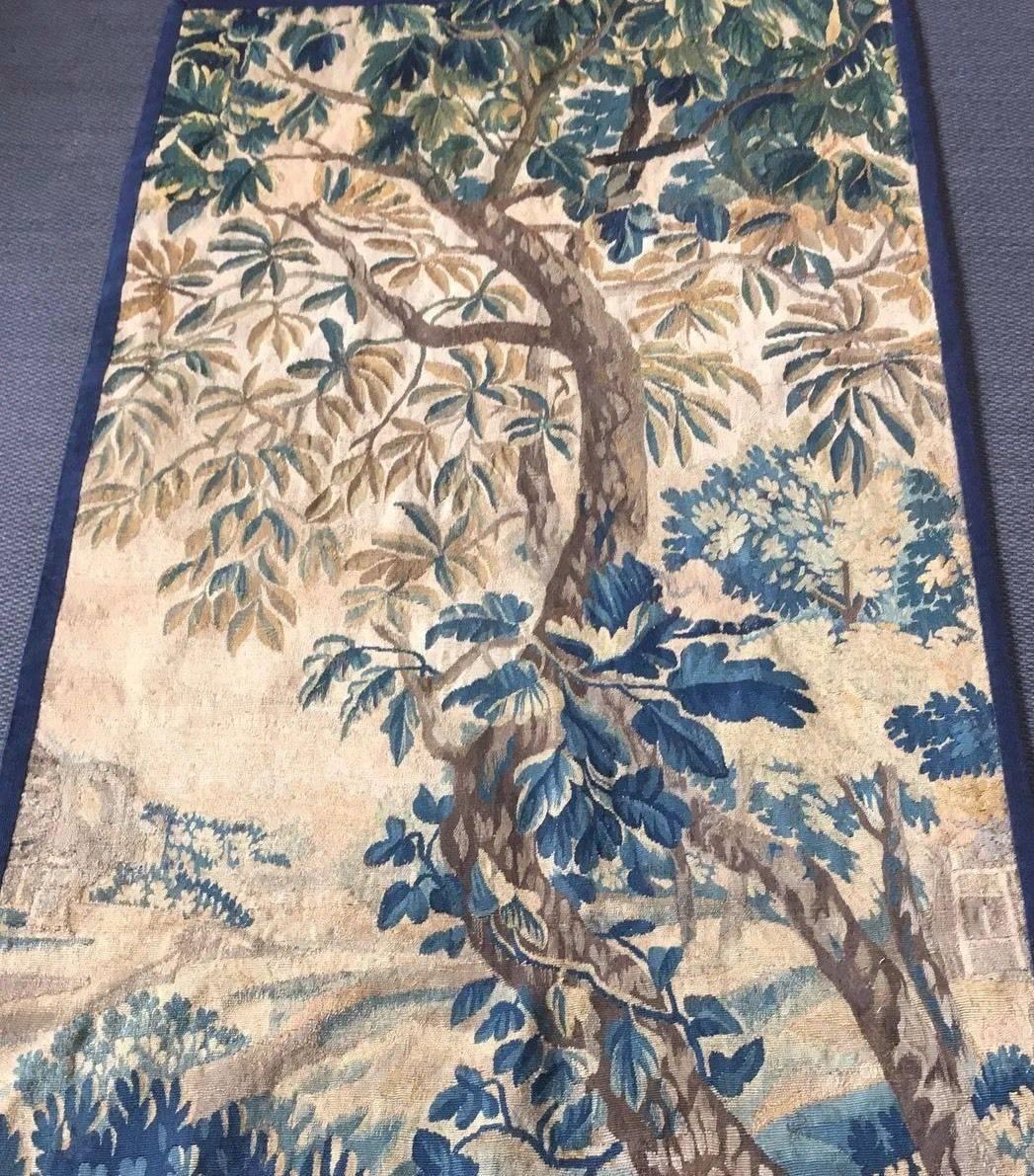 Authentic Brussels tapestry
Early 18th century
After a carton from David Tenier
Depicting a young couple, carrying a basket 
Perfect condition
Blue wool tape border

Silk and wool

Lined and dry cleaned by a restorer.